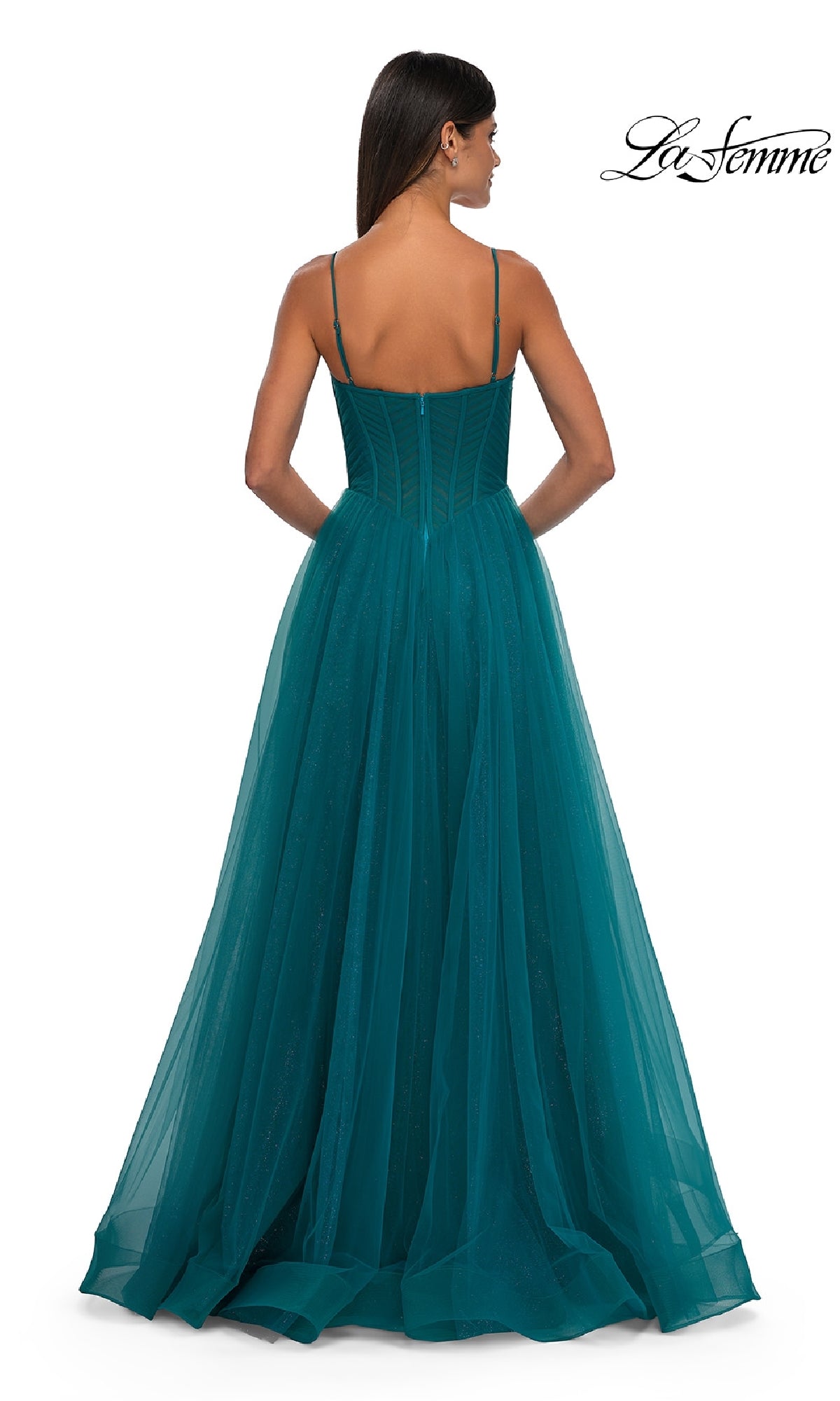 A woman is seen from behind in the La Femme 32680 Long Corset A-Line Prom Dress, featuring a teal color, thin straps, corset bodice, and flowing tulle skirt. The La Femme logo appears in the top right corner.