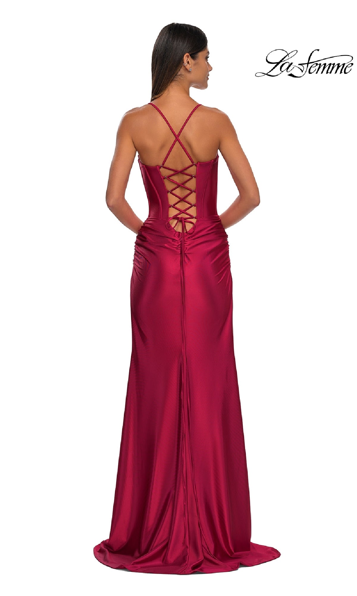 A woman in the Lace-Up Long Satin Prom Dress: La Femme 32683 with a corset-style bodice and crisscross lace-up back, standing and facing away from the camera.