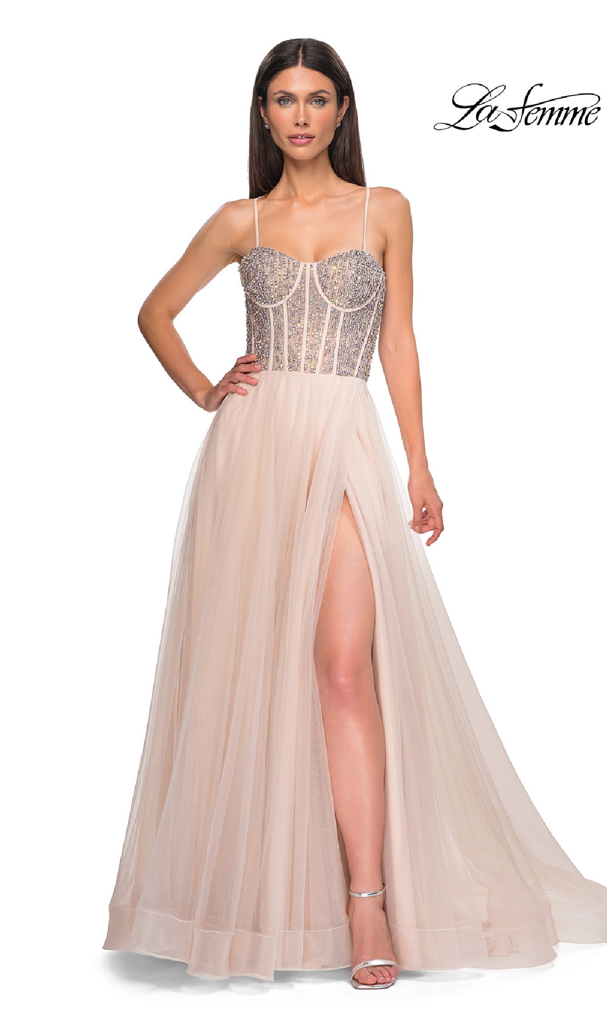 A woman wears the La Femme 32703 Beaded-Corset Long Prom Dress, featuring a sleeveless nude design with rhinestone-beaded bodice, thin straps, and a high-slit skirt. The La Femme logo appears in the top right corner.