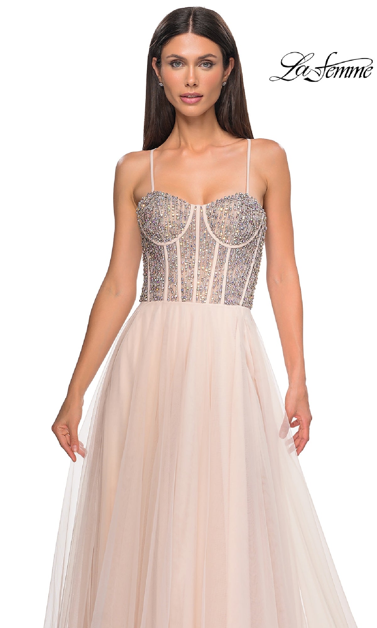 A woman models the Beaded-Corset Long Prom Dress: La Femme 32703 with a rhinestone-beaded corset bodice and sheer, flowing skirt against a white background. The