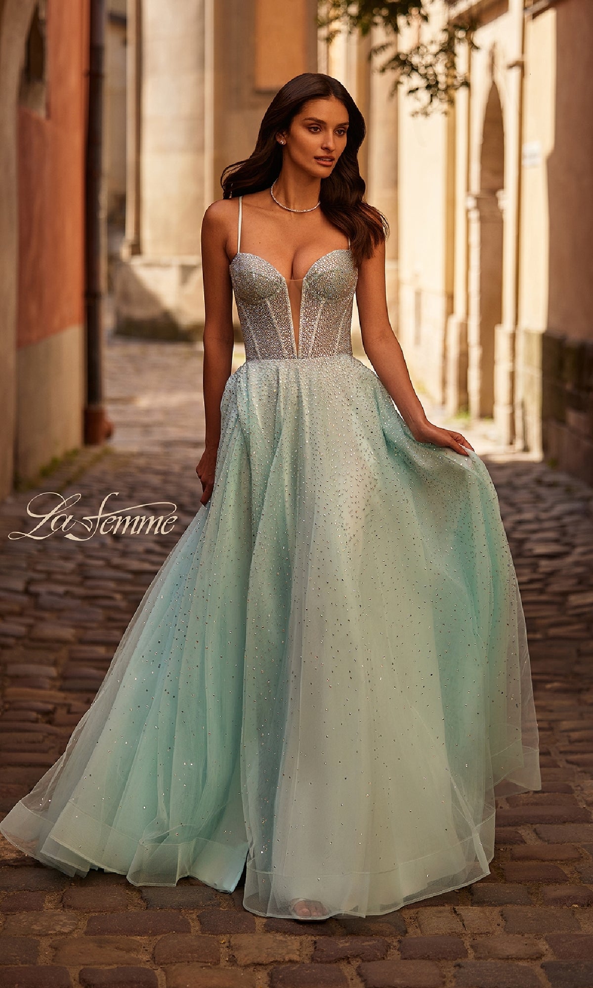 A woman in the Lace-Up Beaded Long Prom Ball Gown: La Femme 32725 radiates stunning elegance.