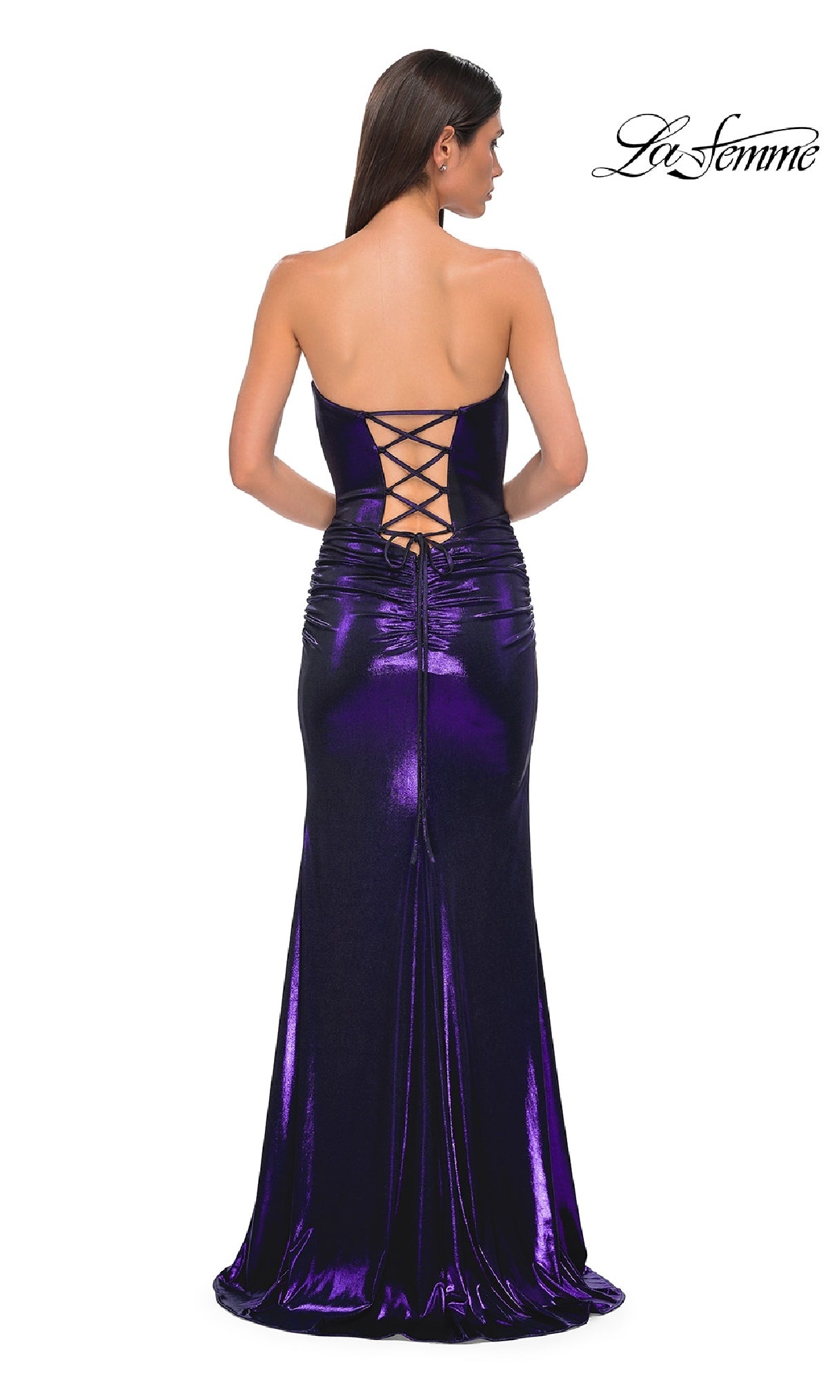 A woman faces away in a strapless, dark purple La Femme 32757 prom dress featuring a sweetheart neckline and lace-up back. The fitted metallic gown is floor-length and shimmers. The La Femme logo is shown in the corner.