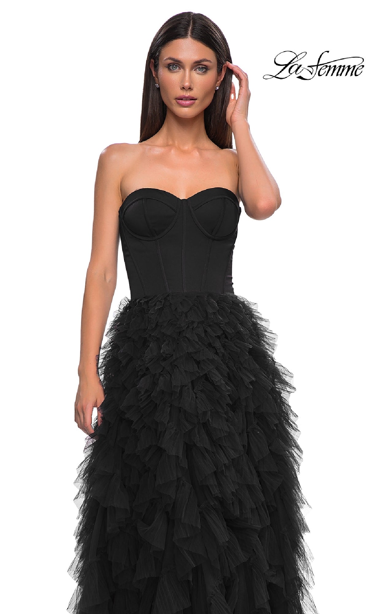 A woman models the La Femme 32760 Strapless Long Ruffled Prom Dress, featuring a corset-style bodice and layered tulle skirt, posed against a white background with the La Femme logo in the top right corner.