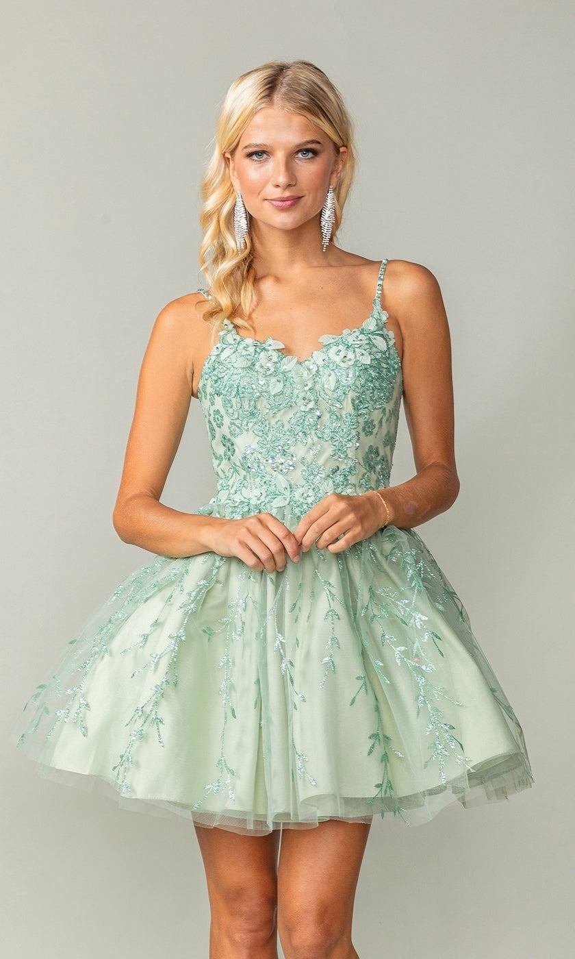 A person models the Embroidered Babydoll Short Glitter Prom Dress in light green, featuring sleeveless styling and floral embroidery, against a plain background.