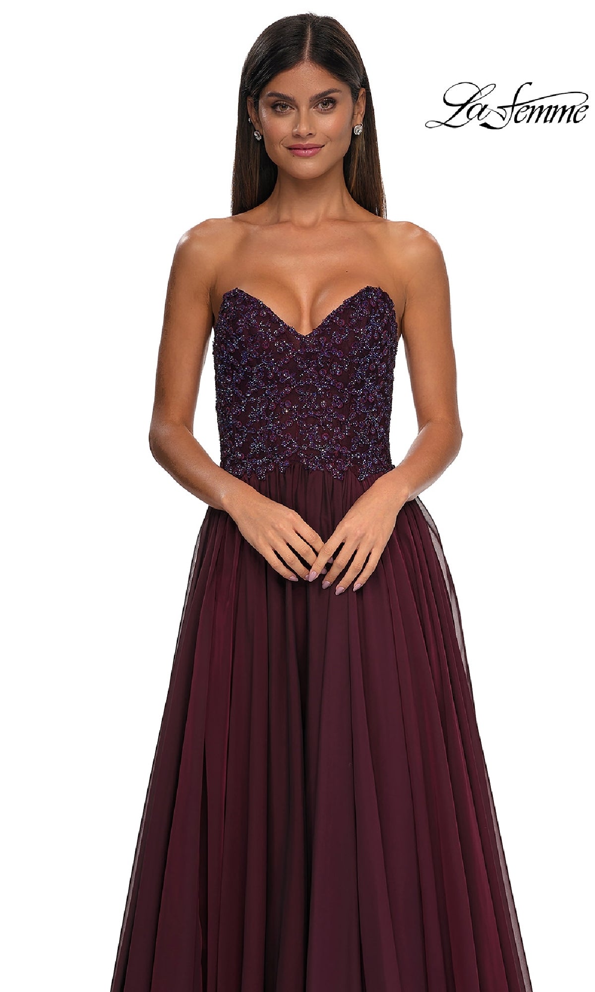 A woman models the La Femme 32804, a strapless long A-line prom dress in burgundy with a beaded bodice, set against a white background. The