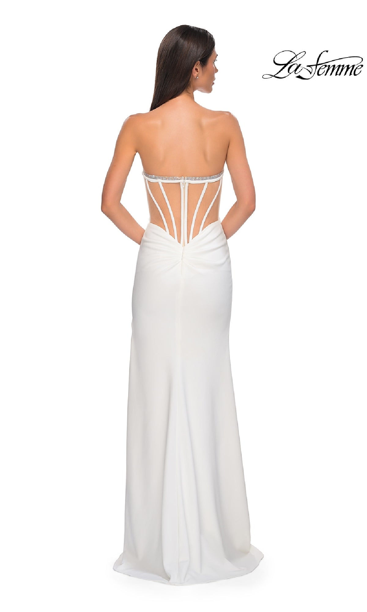 Woman wearing the La Femme 32825 bead-trimmed strapless prom gown with an open back and decorative straps, standing and facing away from the camera. The La Femme logo is visible in the upper right corner.