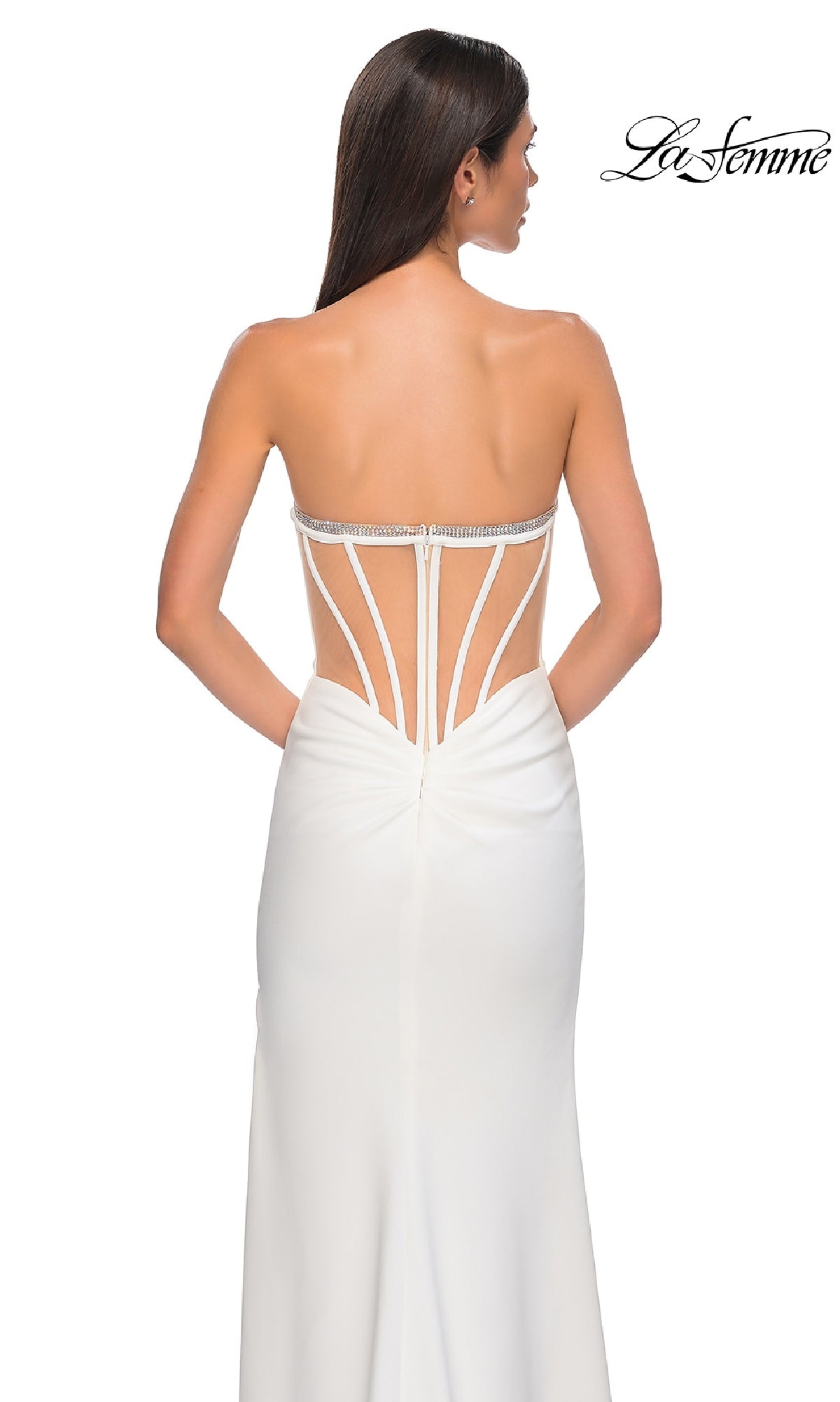 A woman models the Bead-Trimmed Strapless Prom Gown: La Femme 32825, showcasing its strappy open back and bead-trimmed details, viewed from behind against a plain background.