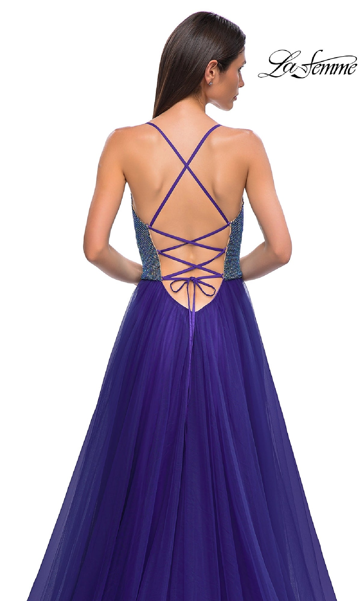 A woman models the La Femme 32838: a long indigo cowl-neck prom dress, featuring an open crisscross lace-up back, standing against a white background.