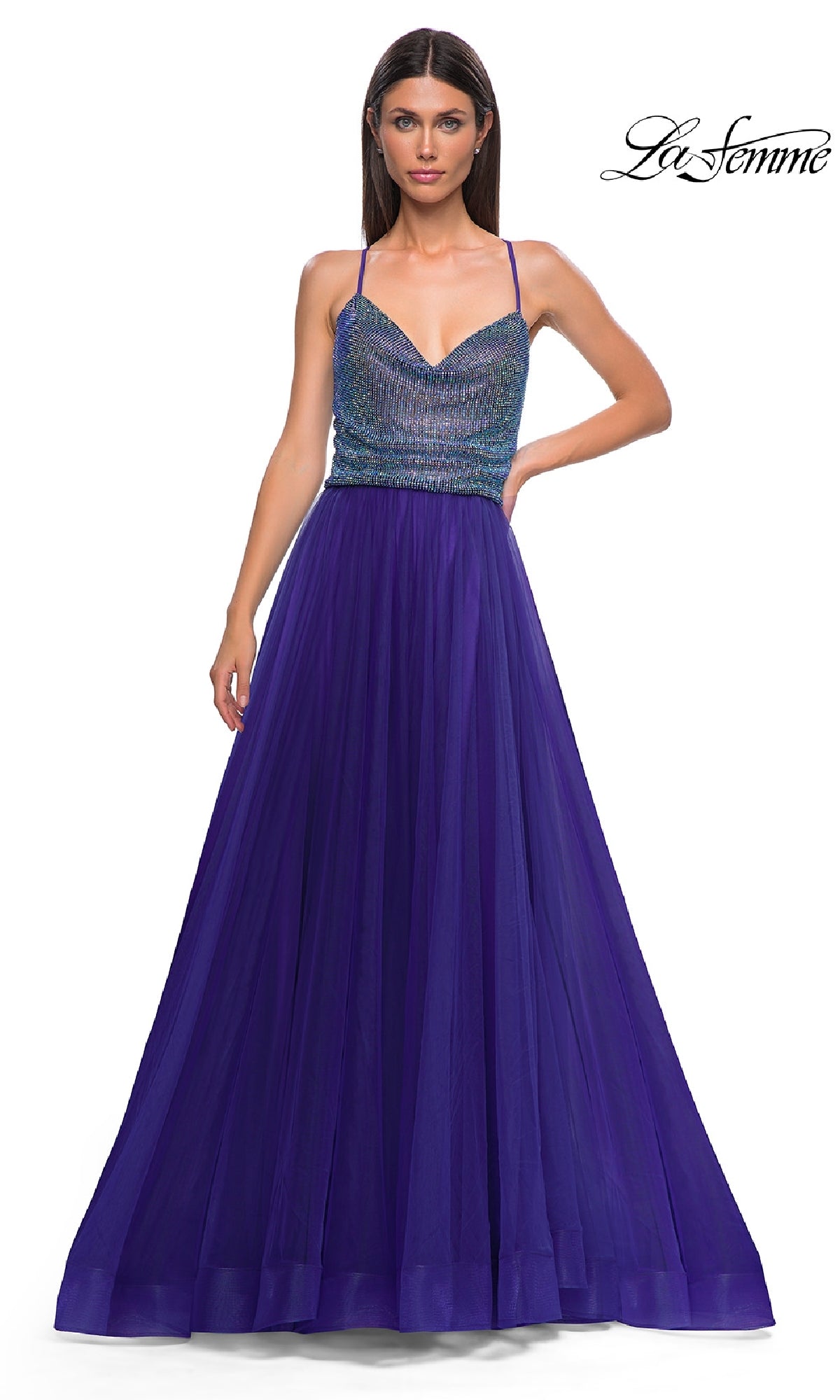 A woman wears the La Femme 32838 Cowl-Neck Long Indigo Prom Dress, featuring a cowl neckline and full-length skirt, posing against a white background.