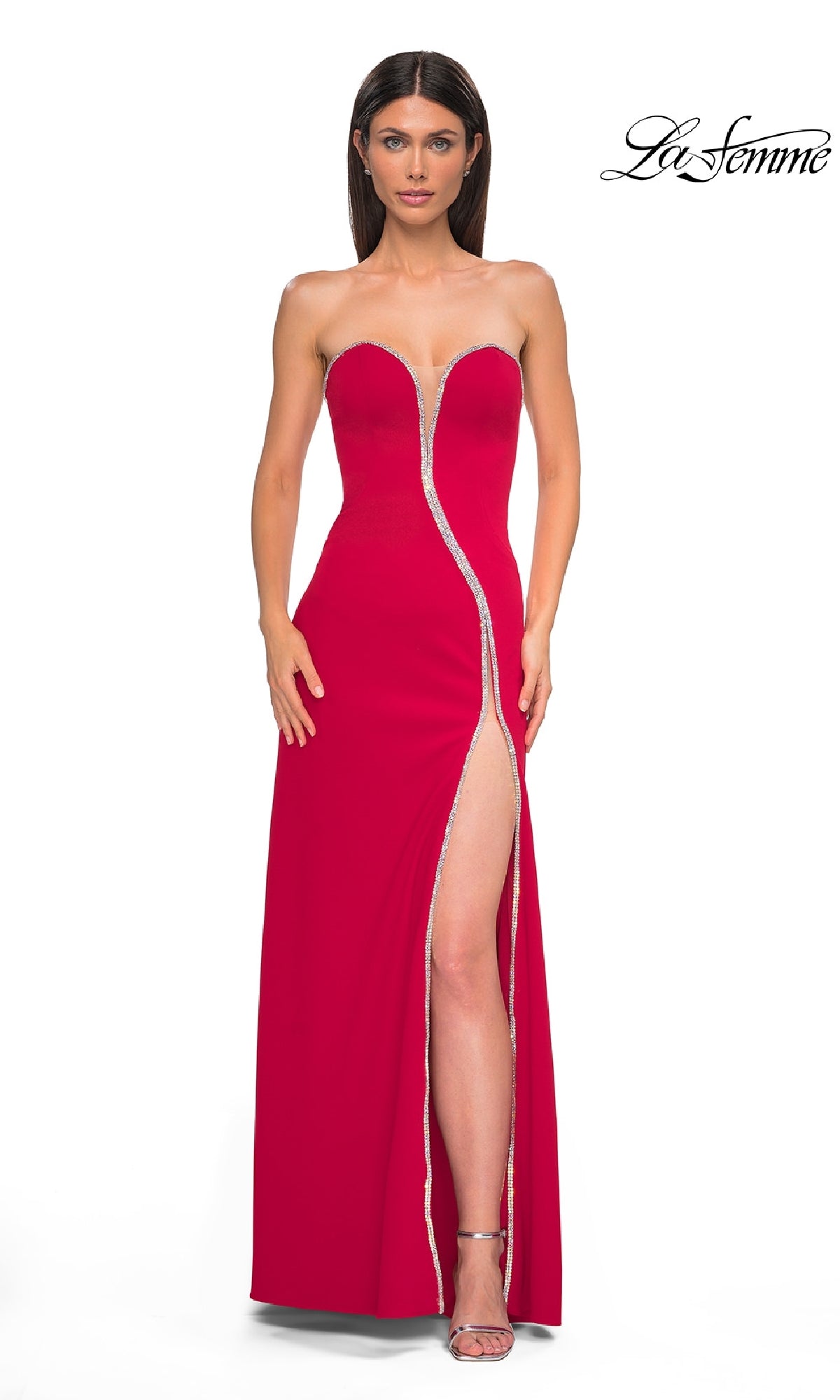 A woman poses in the red Strapless Long Jersey Prom Dress (La Femme 32854) with rhinestone trim and a high slit, against a white background displaying