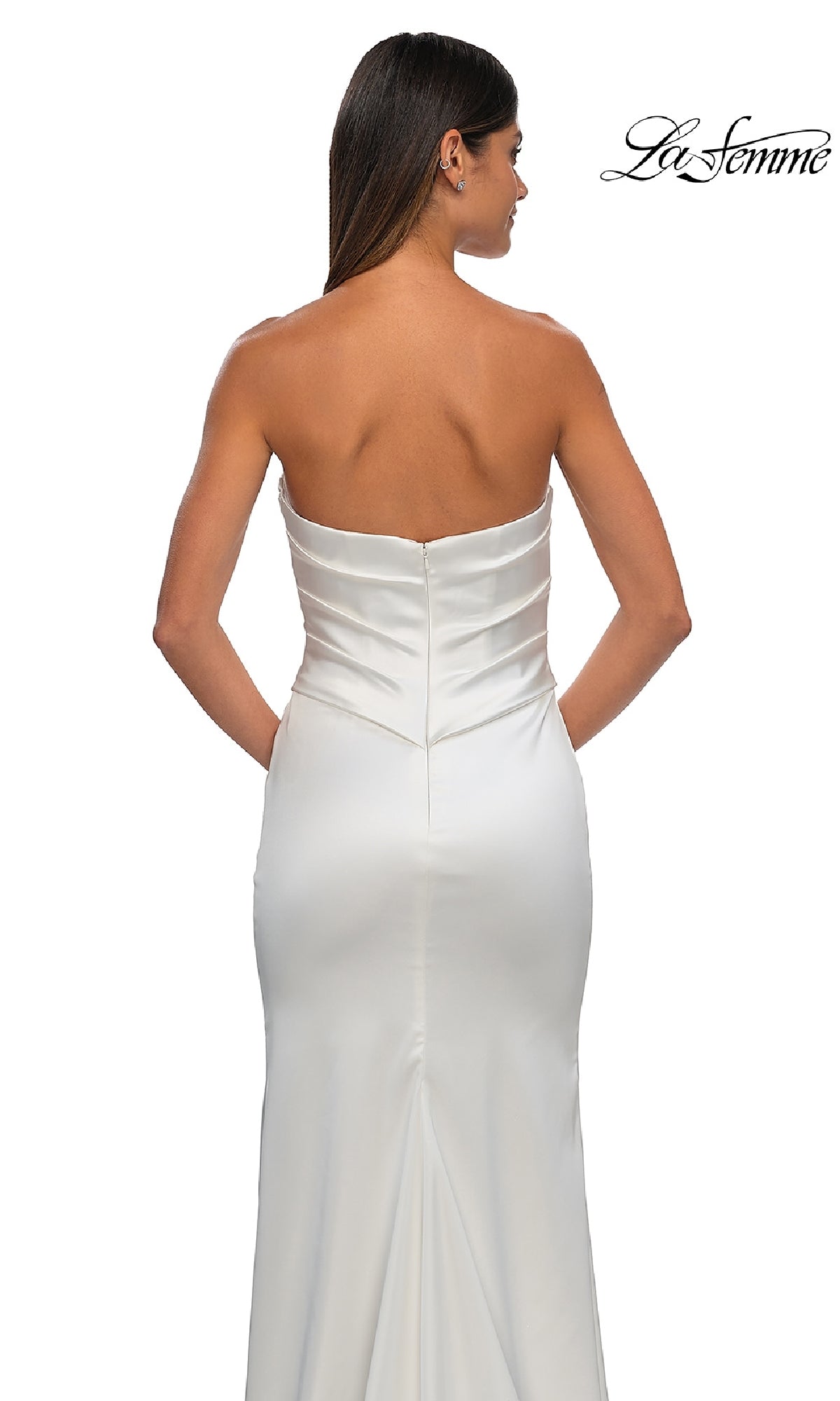 Woman facing away in the Strapless Sweetheart Prom Gown: La Femme 32896—white satin, fitted bodice, smooth long skirt—set against a plain white background with the