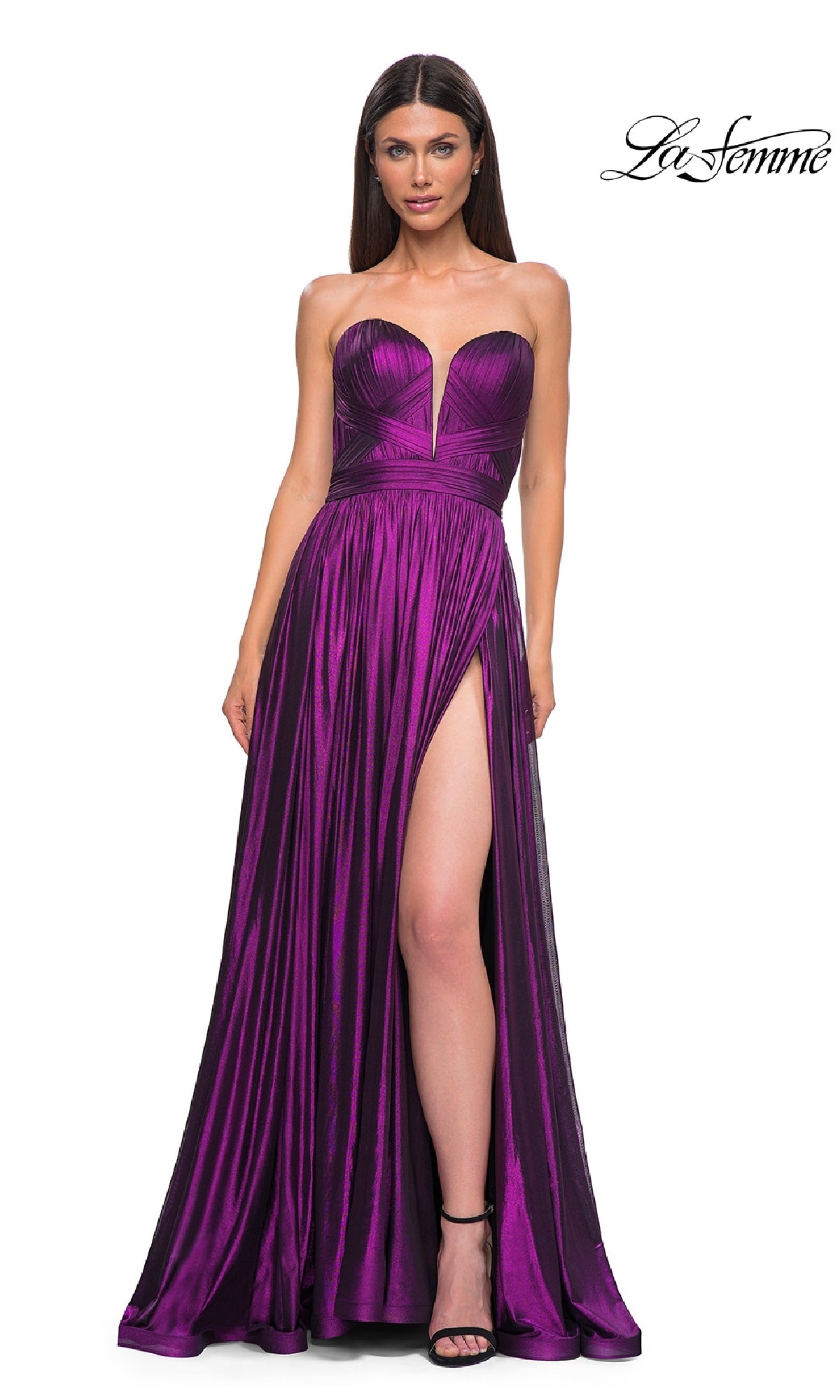A woman wears the Strapless Long Metallic Prom Gown: La Femme 32988 in deep purple, featuring a sweetheart neckline and high slit, standing against a white background with the