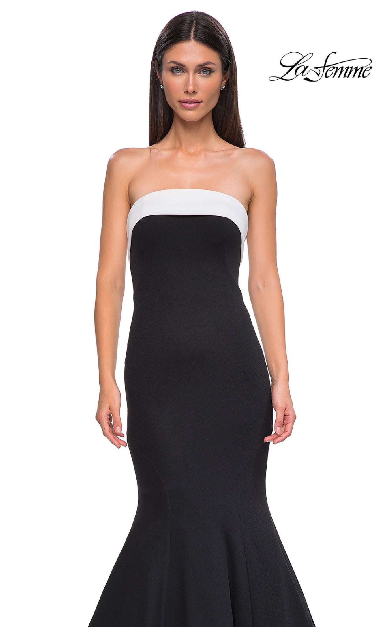 A woman models the Strapless Long Black Prom Dress: La Femme 32914, featuring a white band across the chest in a mermaid silhouette, standing against a plain white background with the