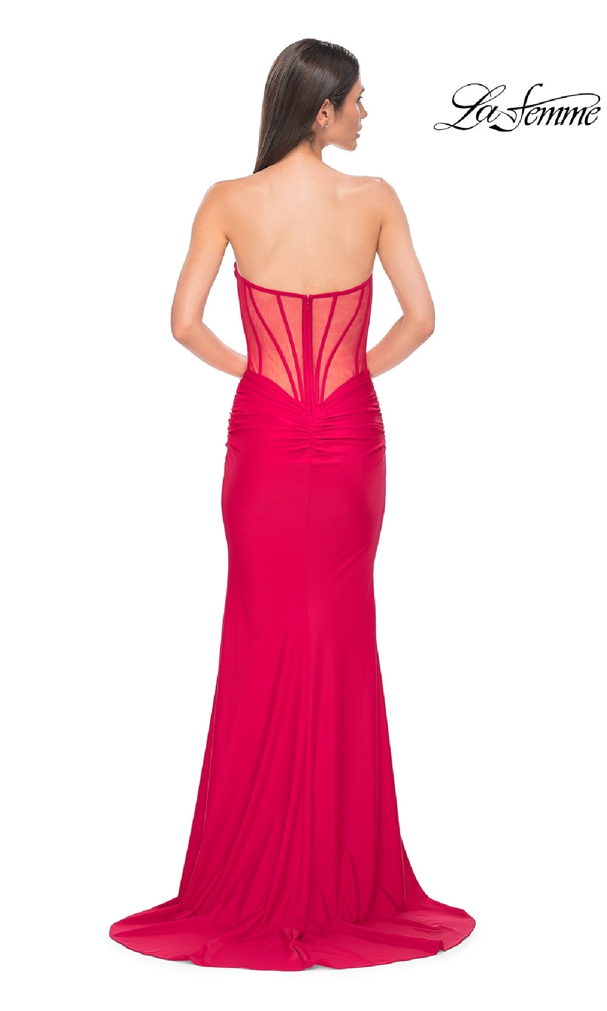 A woman models the La Femme 32941 Strapless Deep V-Neck Prom Gown—floor-length, fitted with a sheer corset-style back—against a white background. The