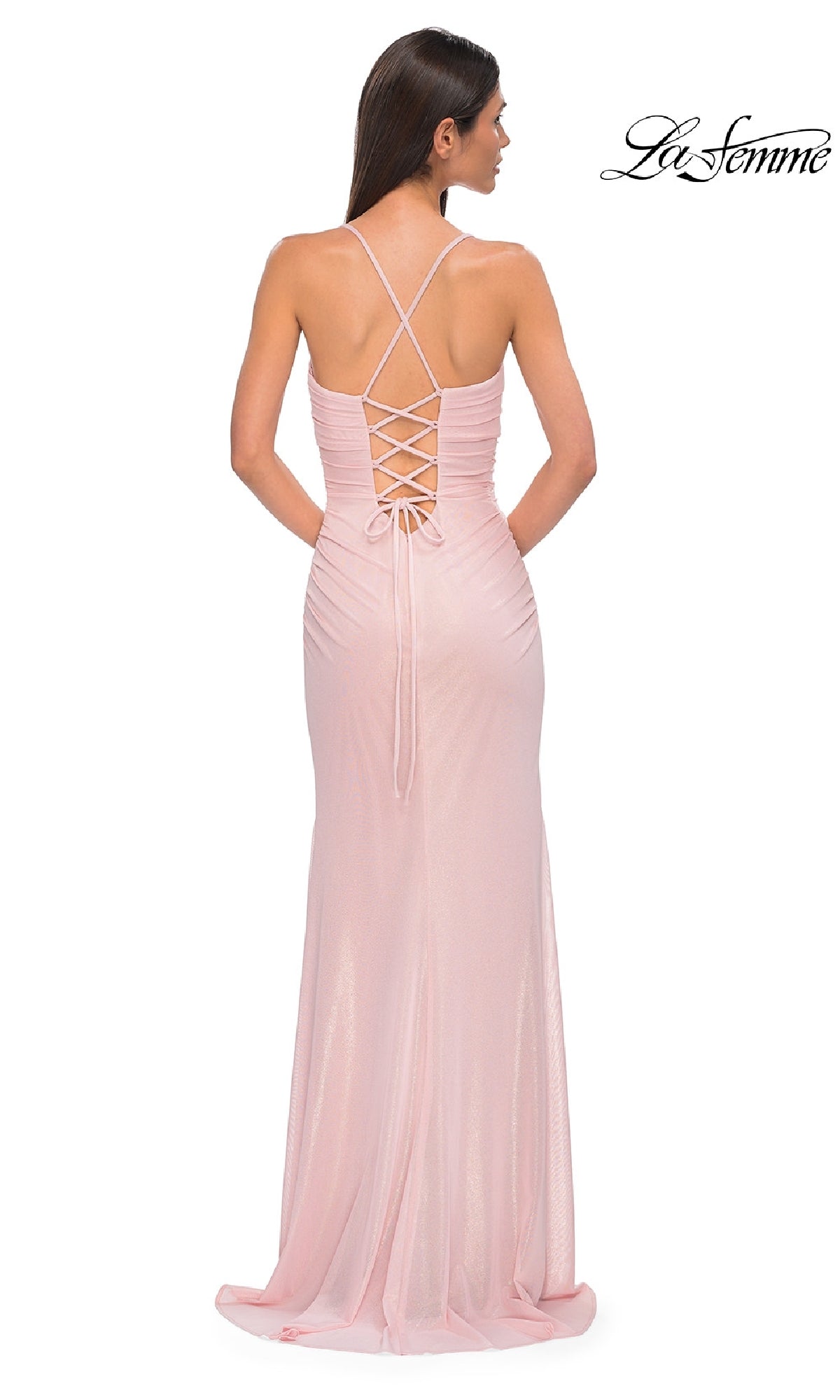 A woman faces away, wearing the La Femme 32964 long prom dress—a light pink, floor-length gown with a crisscross lace-up back and sweetheart neckline. The La Femme logo appears in the top right corner.