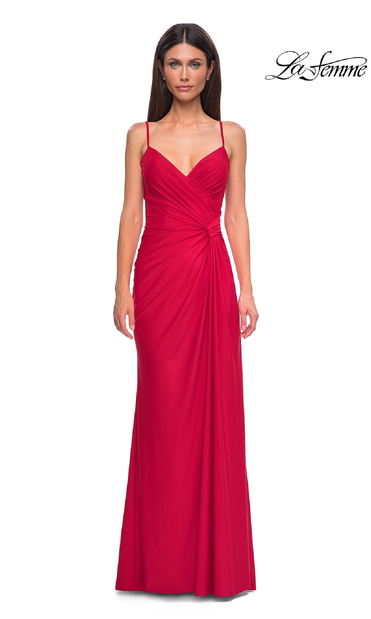 A woman wears the Side-Sash Lace-Up Long Prom Dress (La Femme 32977), a sleeveless, floor-length red gown with ruched detailing and thin straps, standing against a white background. The