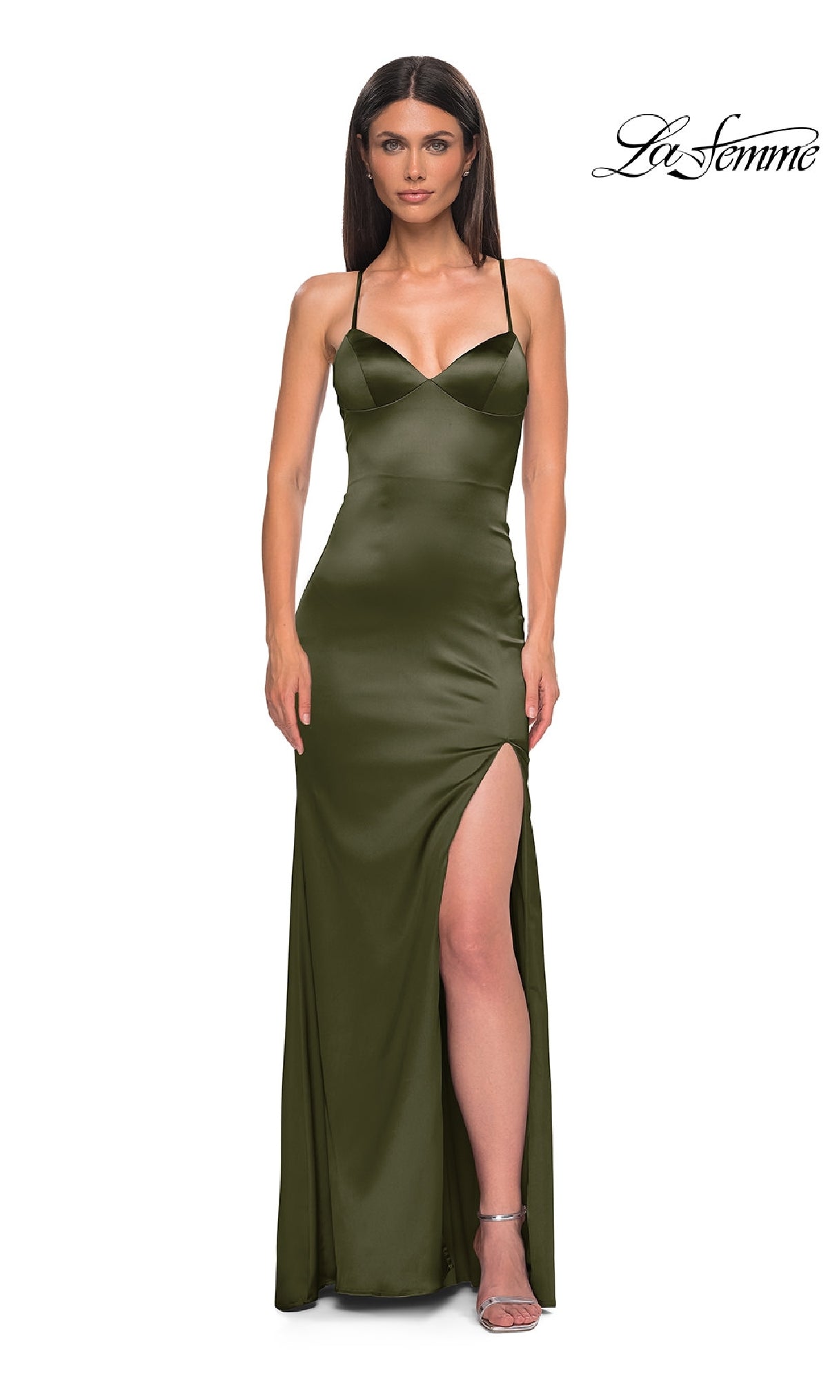 A woman in a La Femme 33010 olive green satin prom dress with thin straps, sweetheart neckline, high side slit, and lace-up back stands against a white background.