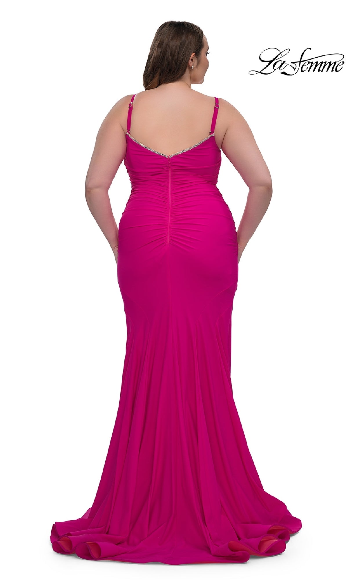 A woman in the La Femme 33057 plus-size floor-length prom dress with thin straps is shown from the back, showcasing the elegance of this stunning bright pink gown.