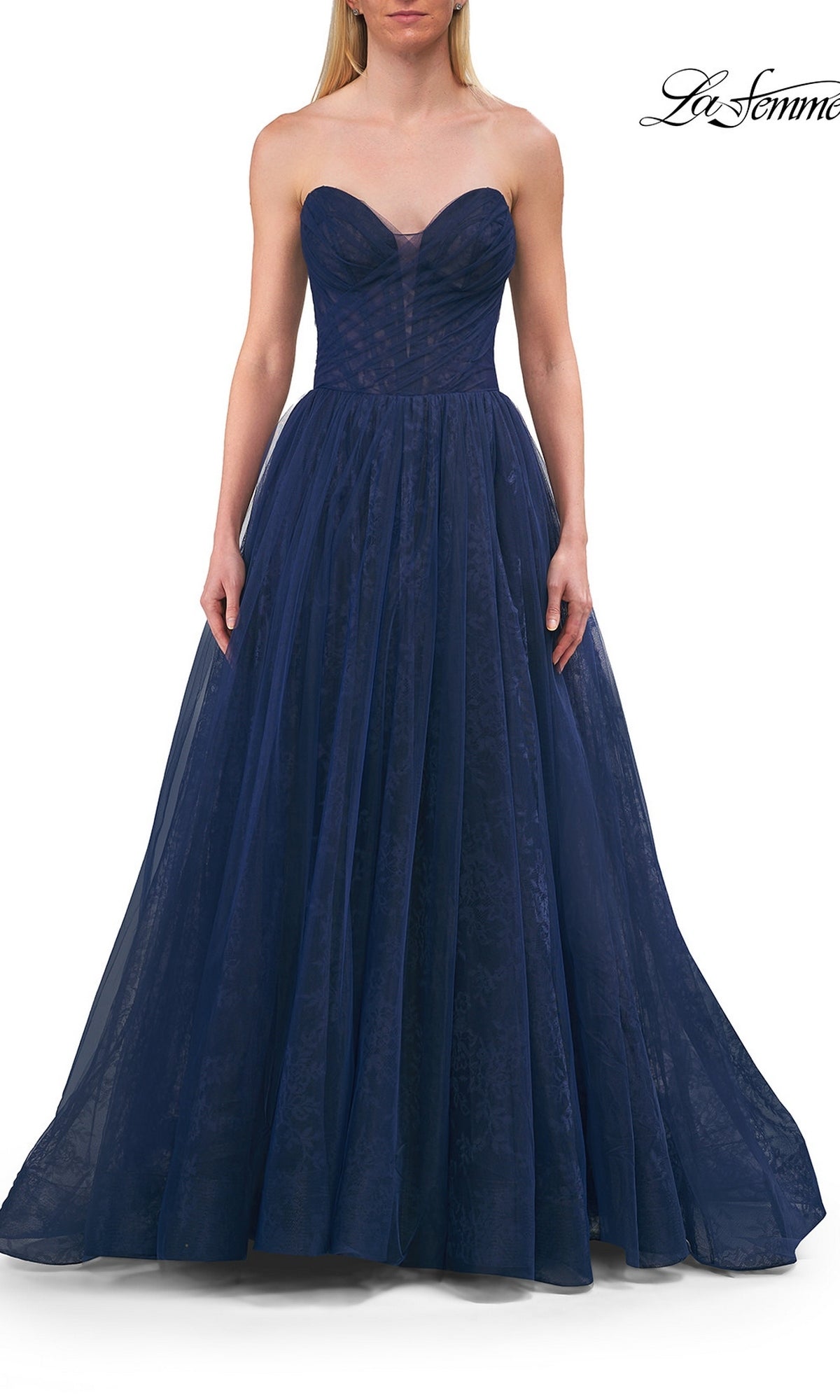 A woman wearing the La Femme 33307 Long Prom Dress—a strapless dark blue ball gown with a fitted bodice and flowing skirt—stands against a white background.