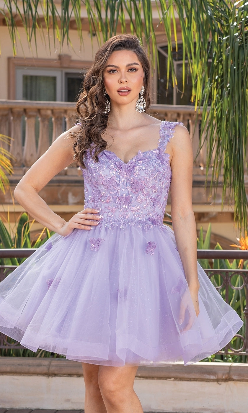 A woman wears the Embroidered-Lace Short Babydoll Hoco Dress 3338, a sleeveless lavender dress with floral lace details and tulle, standing outdoors by a railing and palm trees.