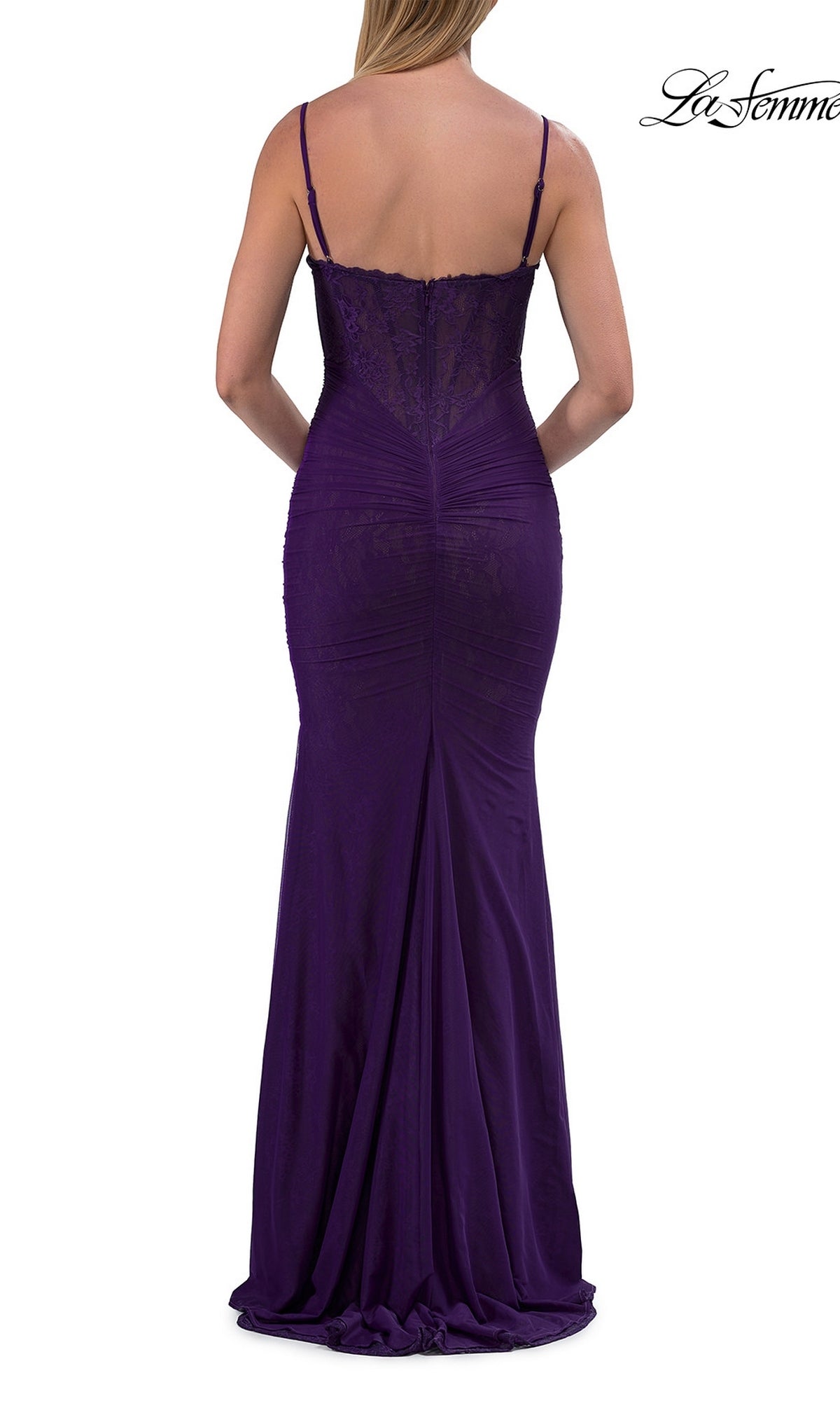A woman is shown from the back wearing the La Femme 33443 Simple Long Lace Prom Dress, a floor-length, fitted designer gown in deep purple with thin straps and a v-neck.