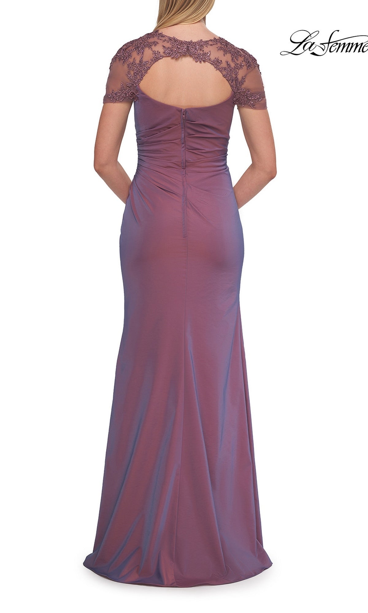 A woman stands with her hands clasped behind her in the La Femme 33579 Back Cut-Out Long Formal Dress—a floor-length, mauve gown featuring short lace sleeves and a keyhole back, making it a graceful choice for a mother of the bride.