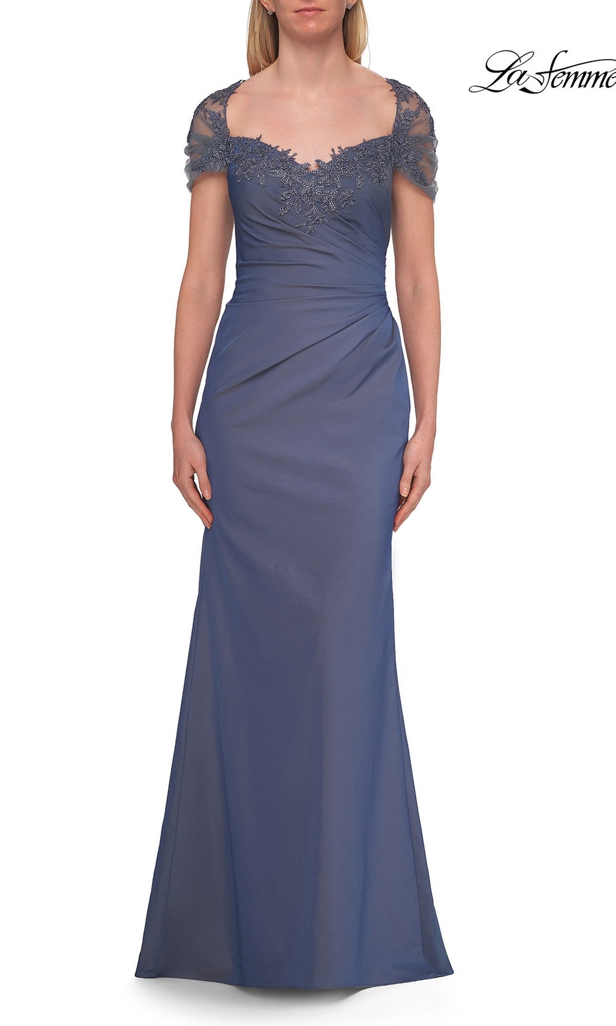 A woman wearing the La Femme 33579 Back Cut-Out Long Formal Dress in slate blue, featuring cap sleeves, lace accents on the neckline and sleeves, and gentle ruching at the waist—an elegant choice for a mother of the bride.