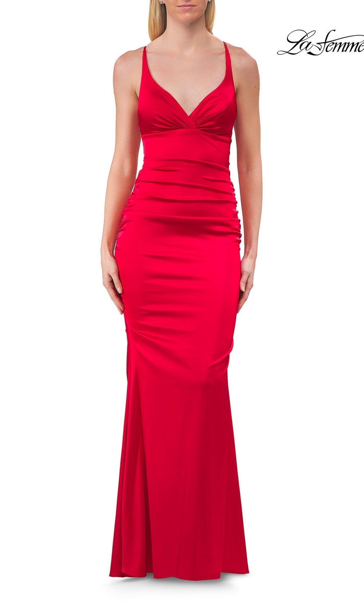 A woman wearing the La Femme 33611 Lace-Up Satin Mermaid Prom Gown in red, featuring a sleeveless, floor-length design with ruched detailing and a V-neckline. This fitted evening gown is perfect for making an elegant statement.