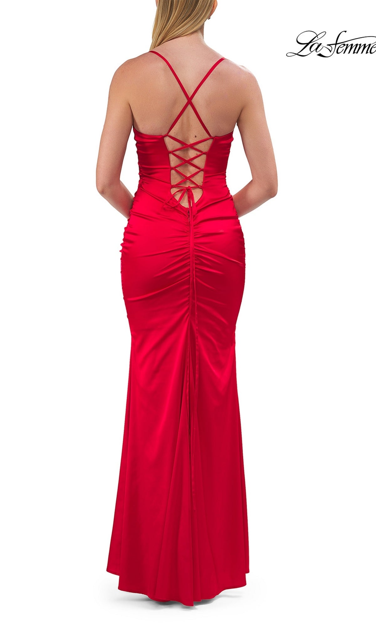 A woman wearing the Lace-Up Satin Mermaid Prom Gown: La Femme 33611 in red, featuring crisscross straps and a lace-up back detail, photographed from behind.