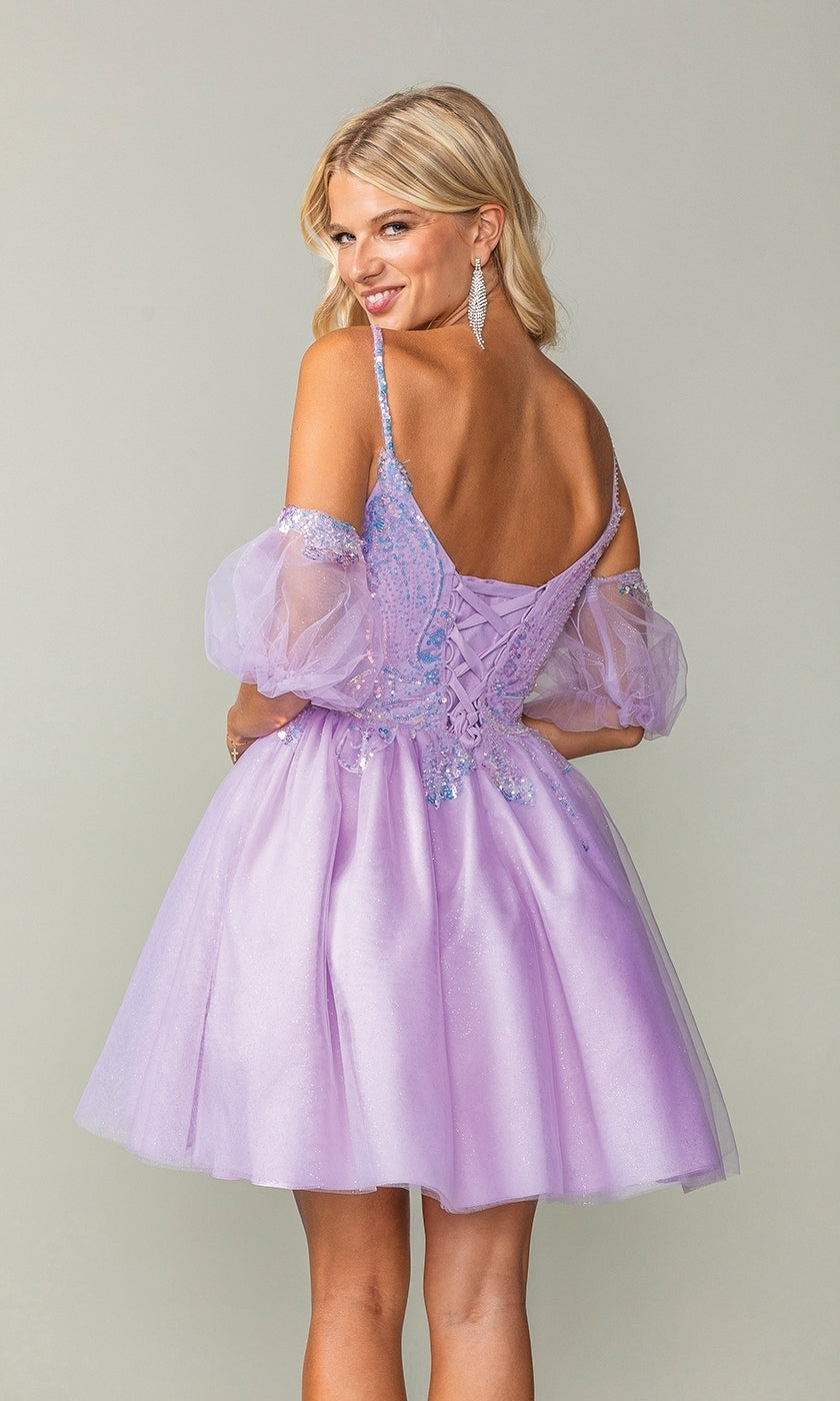 A woman wearing the Puff-Sleeve Short Purple Homecoming Dress 3362, featuring off-shoulder tulle sleeves and a lace-up back, stands facing away, looking over her shoulder with a smile.