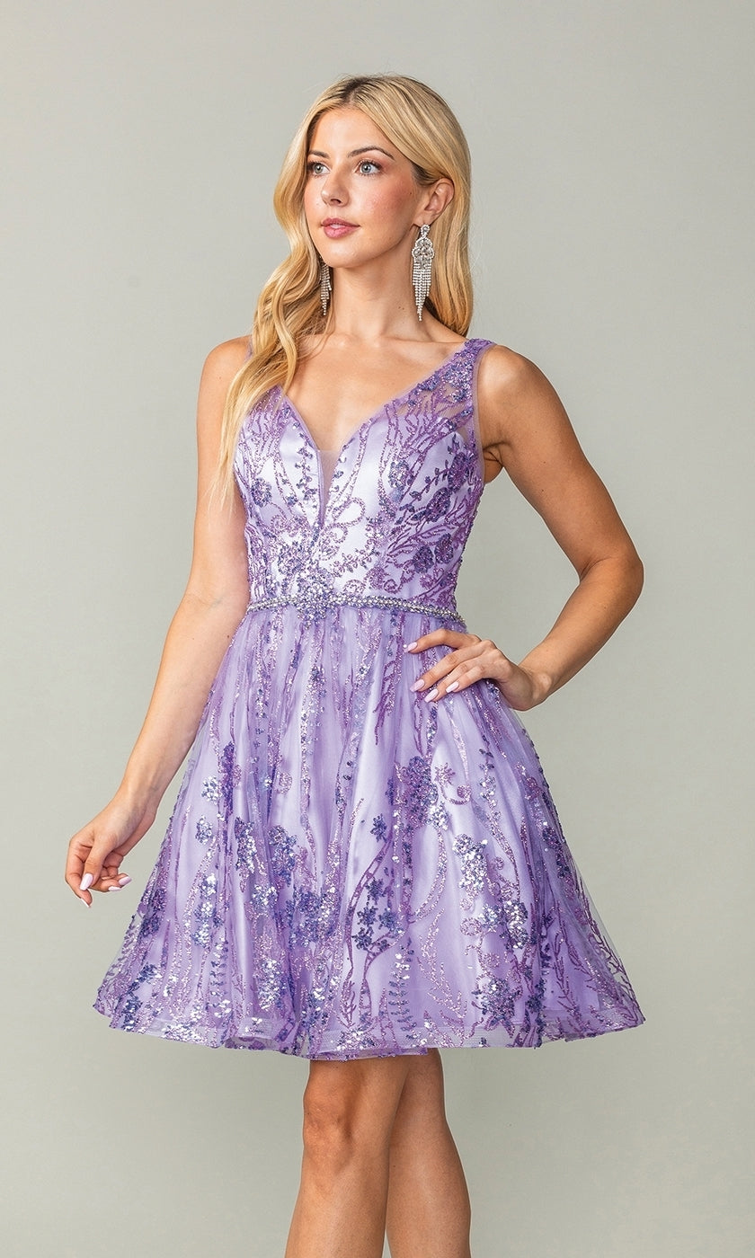 A woman stands against a plain background wearing the Dancing Queen 3364, a short lavender glitter-print homecoming dress with floral sequin embellishments, sleeveless design, deep V-neckline, and fitted waist.