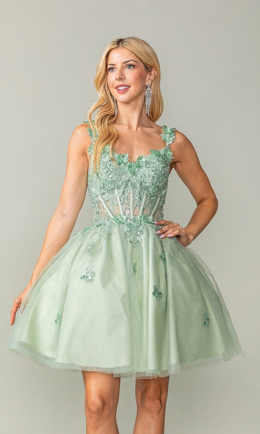 A woman poses against a plain background wearing the Rose Gold Short Butterfly Homecoming Dress 3367—a sleeveless, semi-formal dress with a corset bodice and butterfly appliqués.