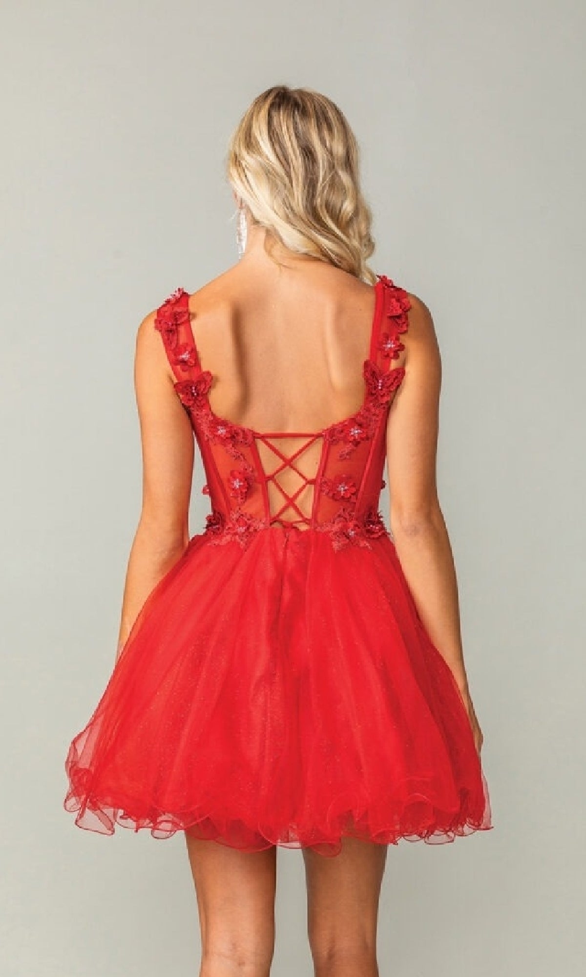 Red dress with floral details on a plain background