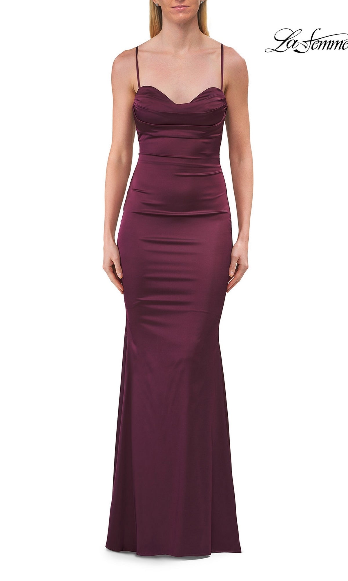 A woman wearing the La Femme 33764 Criss-Cross Open-Back Prom Gown in Dark Berry, a sleeveless, floor-length, fitted formal dress with thin straps, stands against a white background.