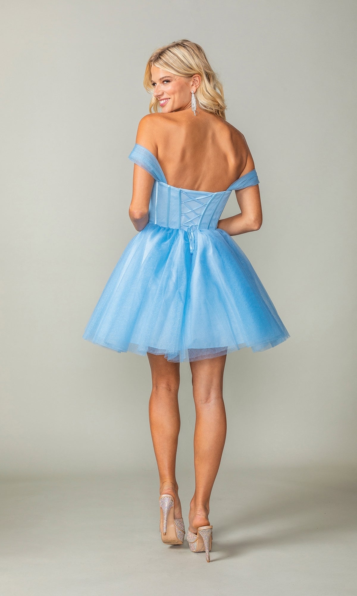 Woman in heels with her back to the camera wearing the Off-Shoulder Short Fit-and-Flare Hoco Dress 3394, a light blue cocktail dress featuring a corset-style bodice and tulle skirt.
