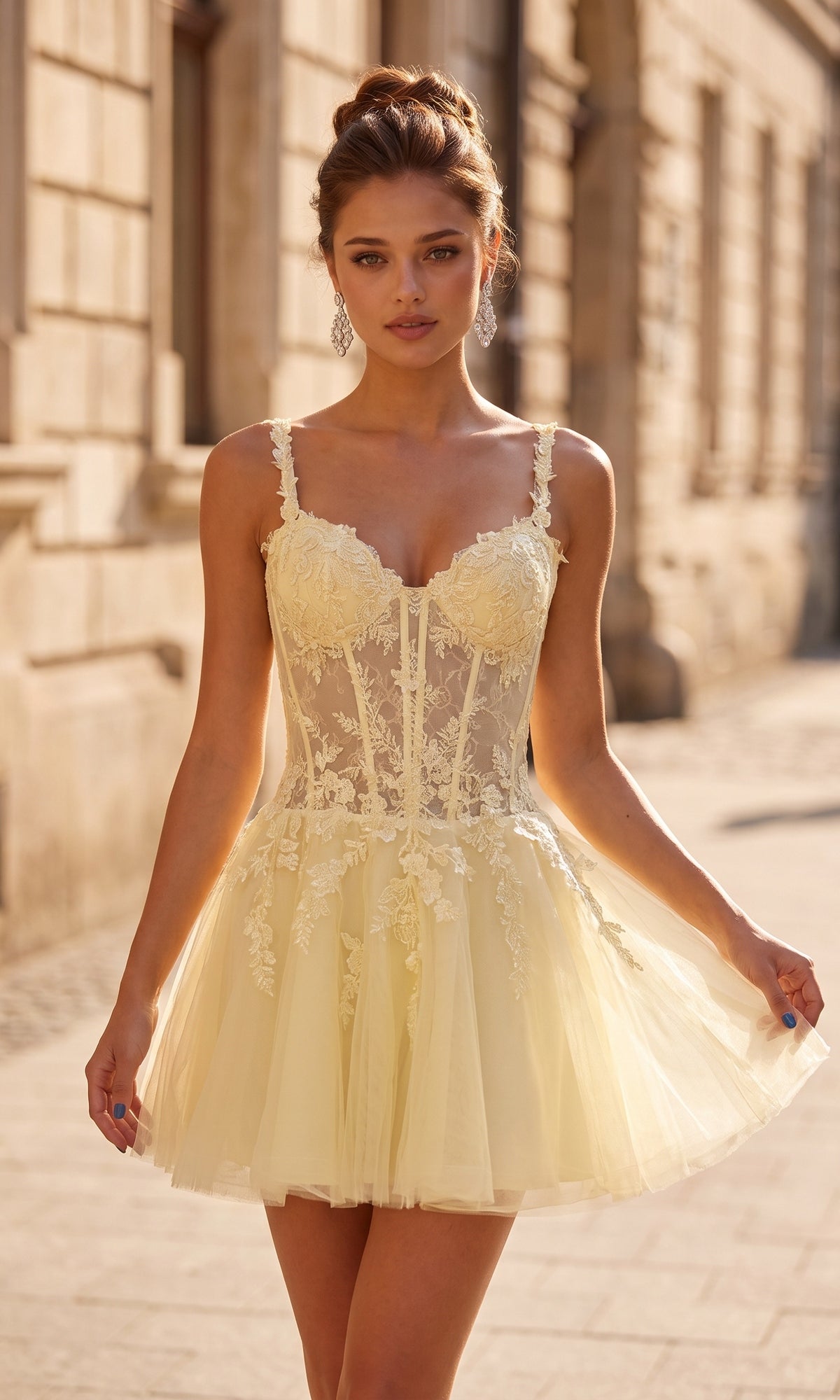 Wearing the La Femme 34146 short homecoming dress in pale yellow, a woman stands outside on a stone-paved street.