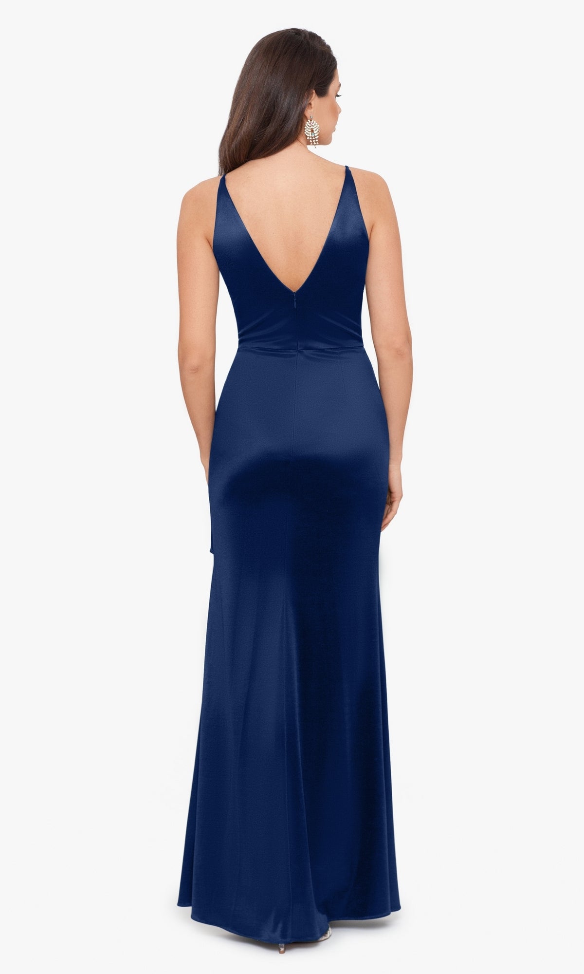 A woman stands against a plain white background wearing the Blondie Nites Side Drape Long Formal Dress 3458BN, a sleeveless, floor-length navy gown with a deep V-back.
