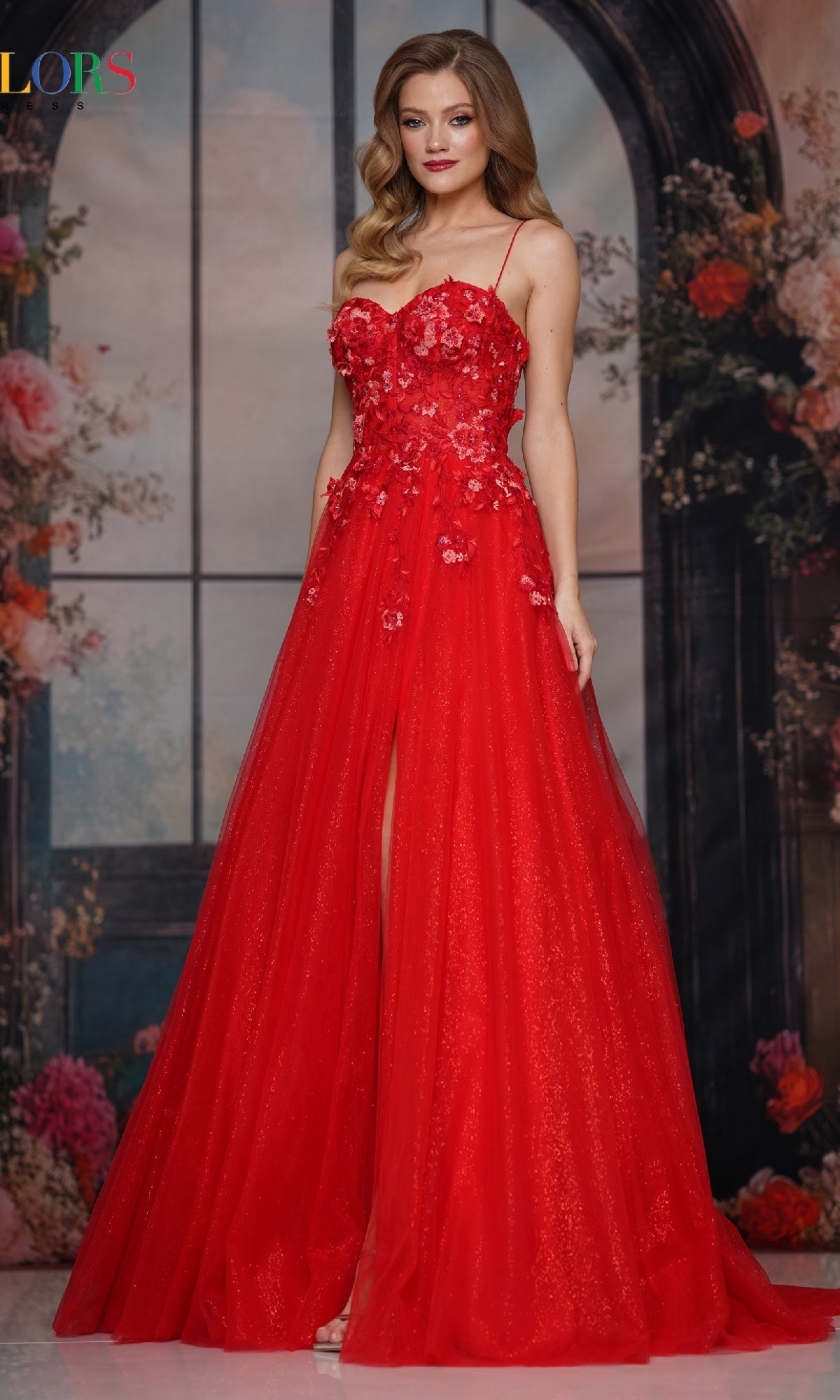 A woman poses in front of a floral and windowed backdrop wearing the Pastel Long Prom Ball Gown: Colors Dress 3496.