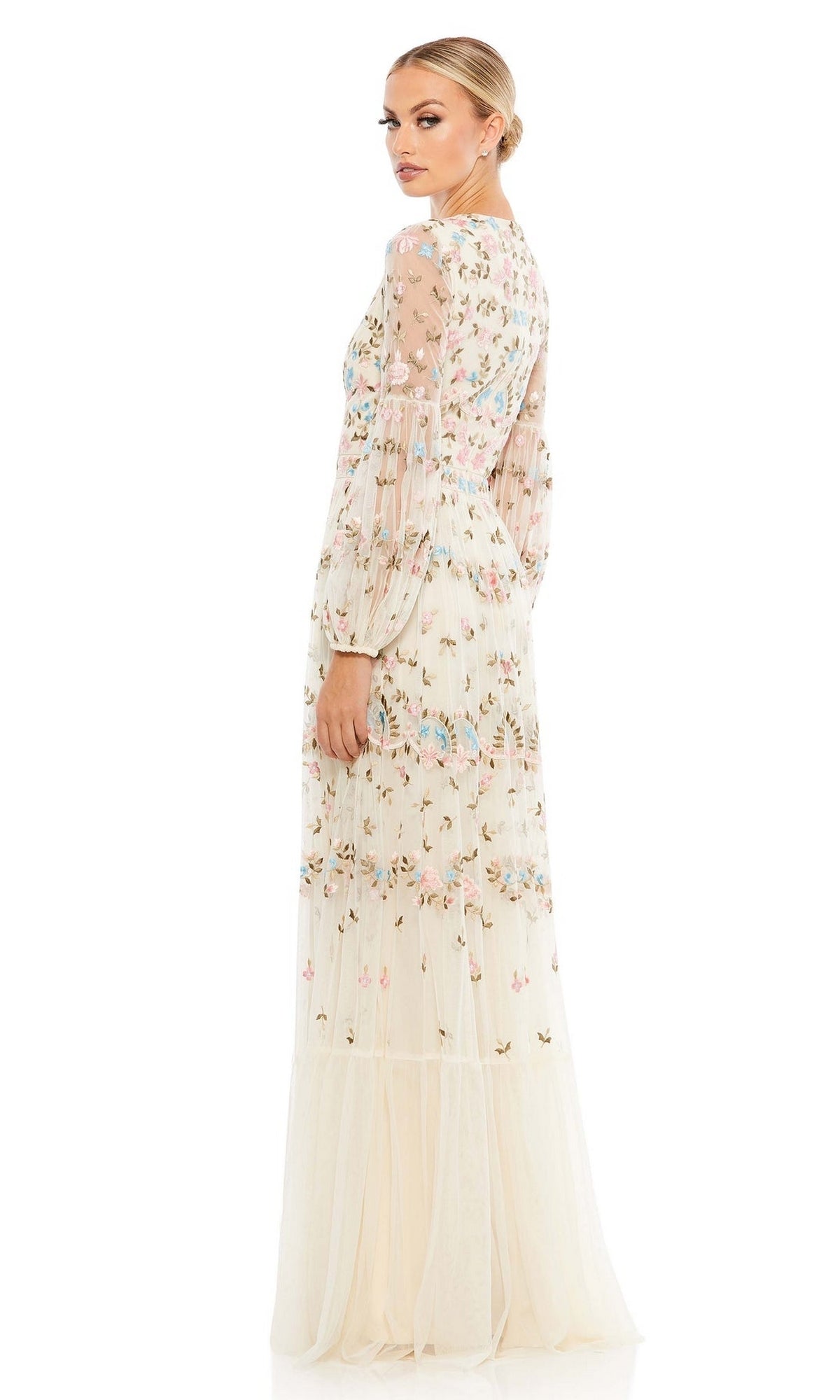 A woman stands against a white background, looking over her shoulder in the Long Formal Dress 35111 by Mac Duggal—a cream-colored, floral embroidered A-line gown with long sleeves and a fitted waist.