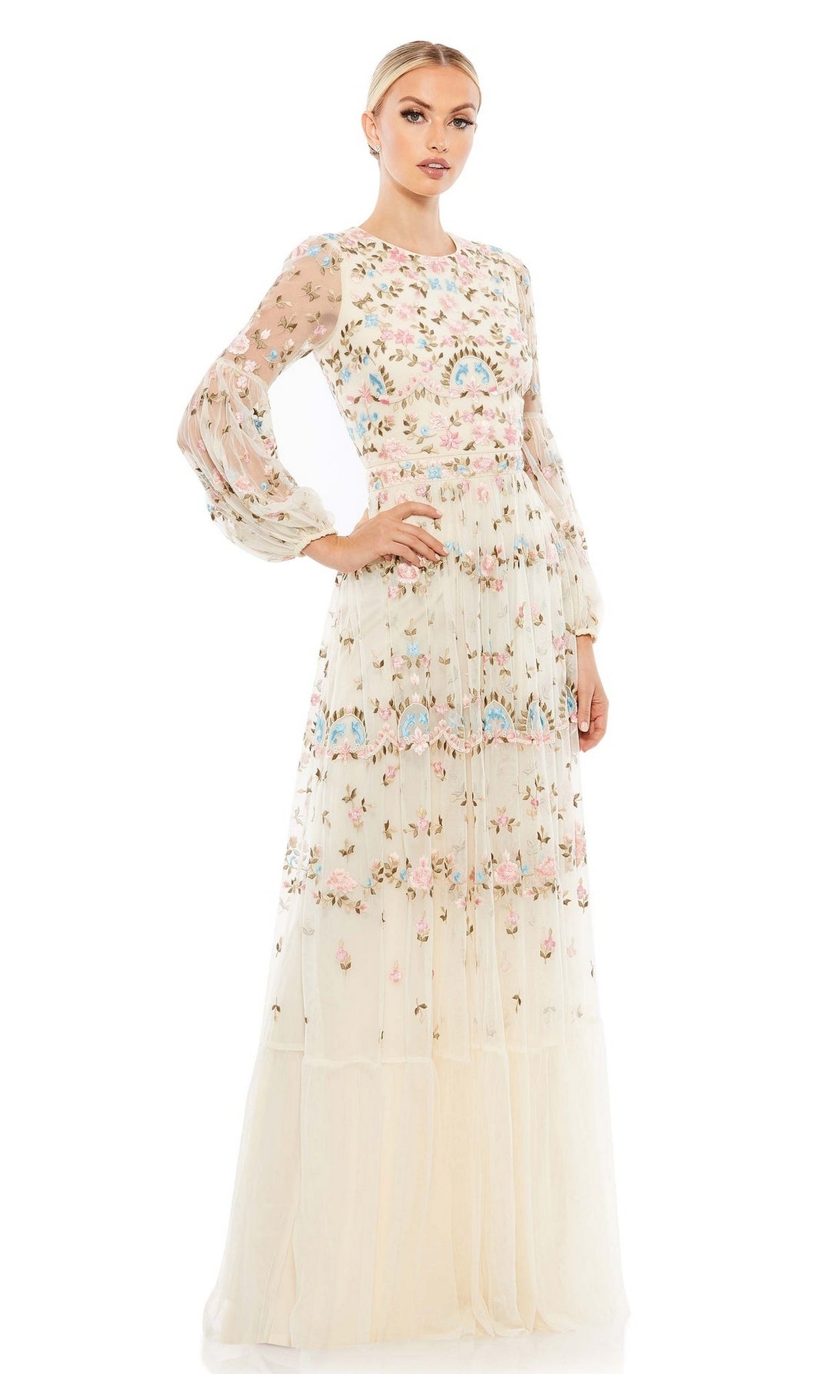 A woman poses against a plain white background wearing the Long Formal Dress 35111 by Mac Duggal, a floor-length gown featuring colorful floral embroidery and long, semi-transparent sleeves.