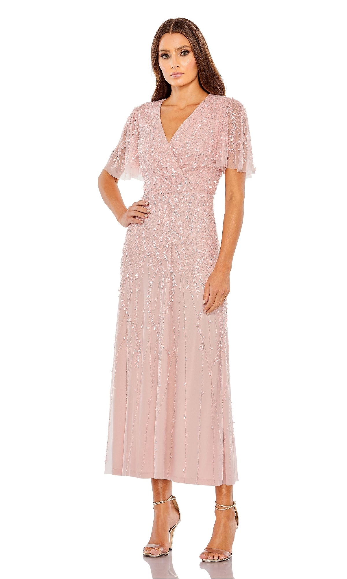 A woman wearing the Beaded Midi Semi-Formal Dress: Mac Duggal 35116 paired with metallic strappy heels stands against a white background.