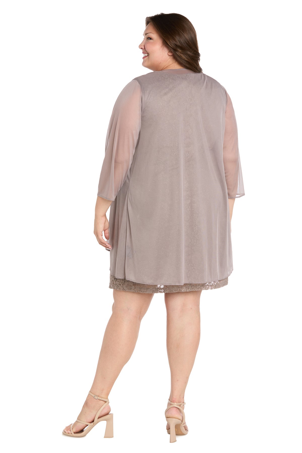 A woman stands facing away from the camera, wearing the R&M Richards Plus-Size Short Jacket Dress (3594W) in light taupe with sheer sleeves and nude heels.