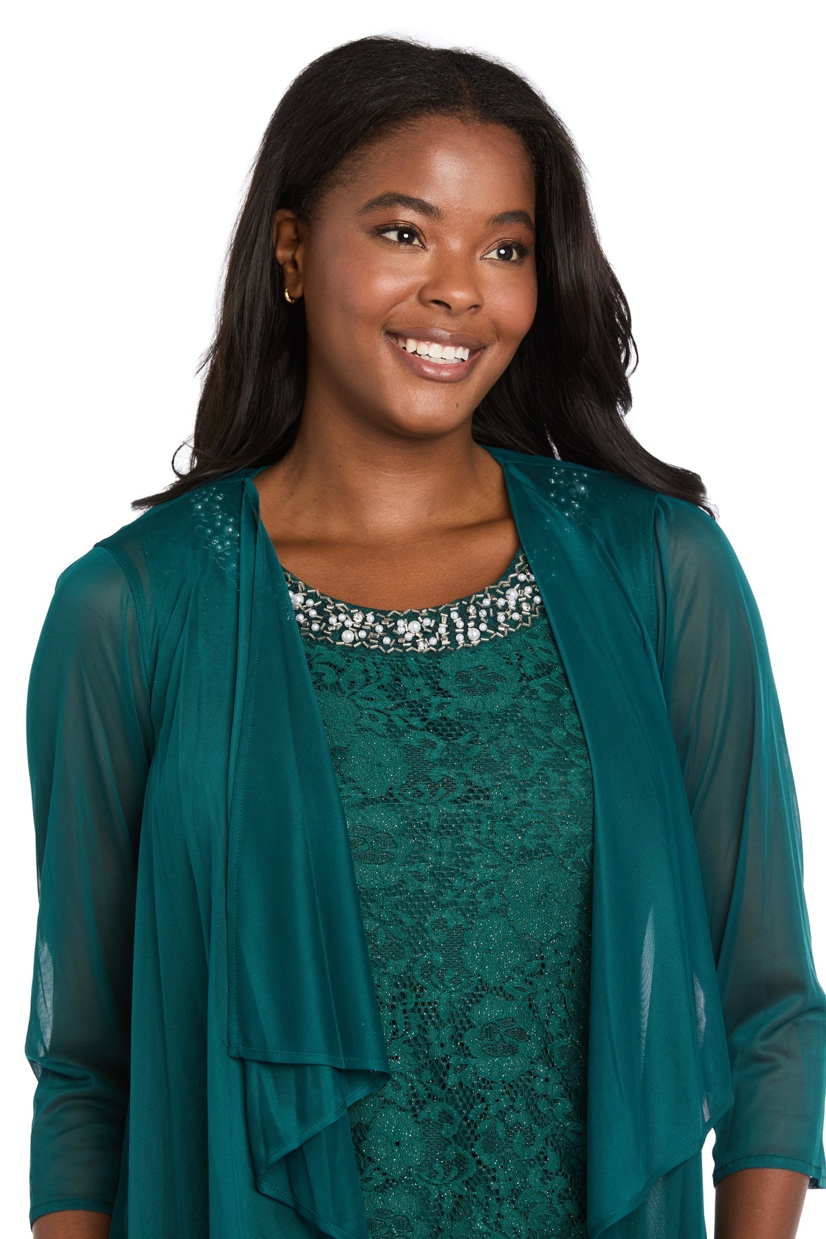 A woman in the R&M Richards 3594 Short Semi-Formal Jacket Dress smiles and looks to the side, showcasing a chic teal knee-length lace style against a white background.