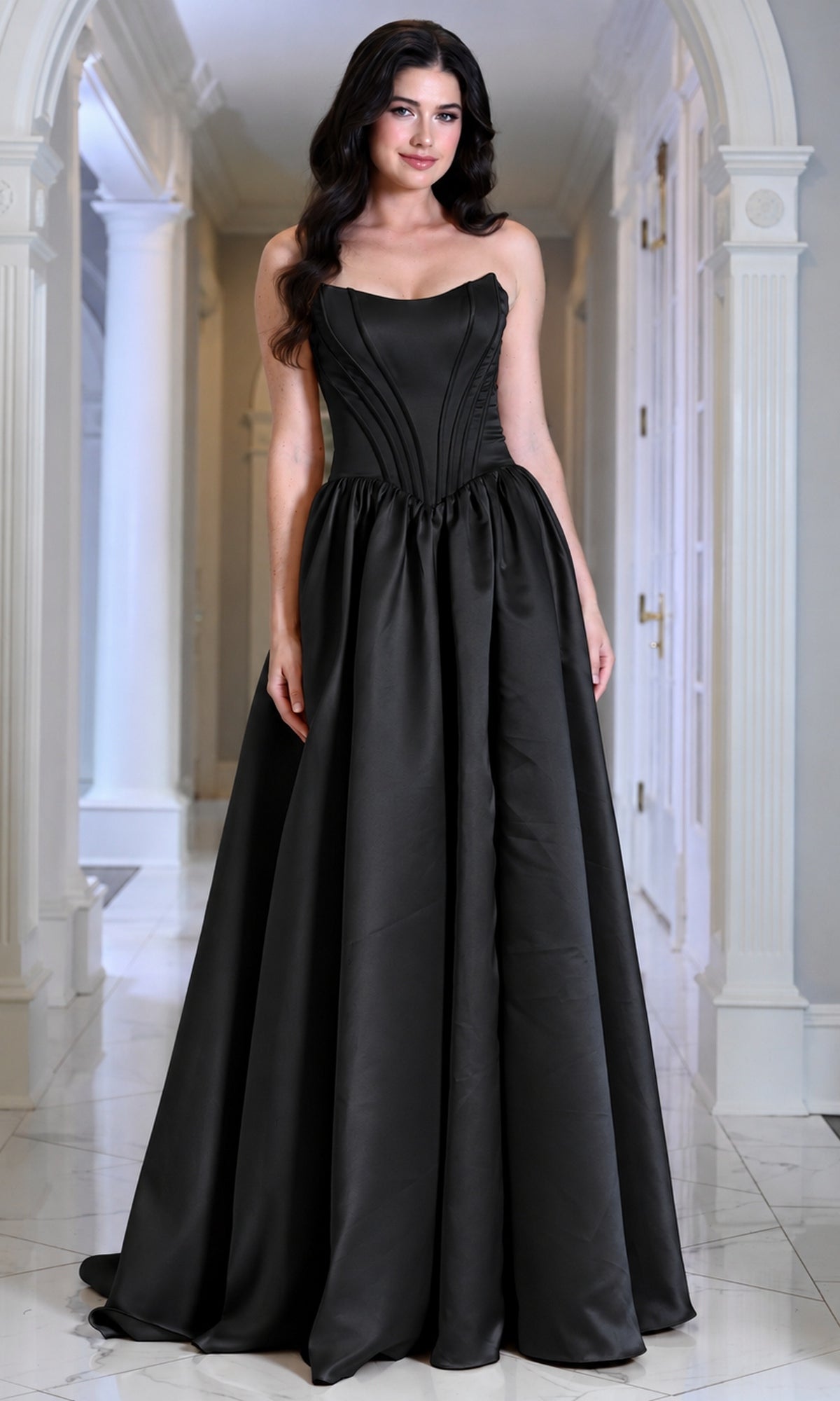 A woman wearing a black Colors Dress 3997, a floor-length, strapless corset prom dress with a full skirt.