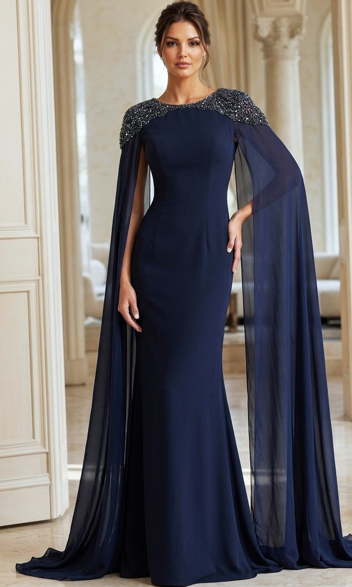 A woman stands in a room wearing the Jovani 40000 long formal dress in navy, featuring chiffon cape sleeves and embellished shoulders.