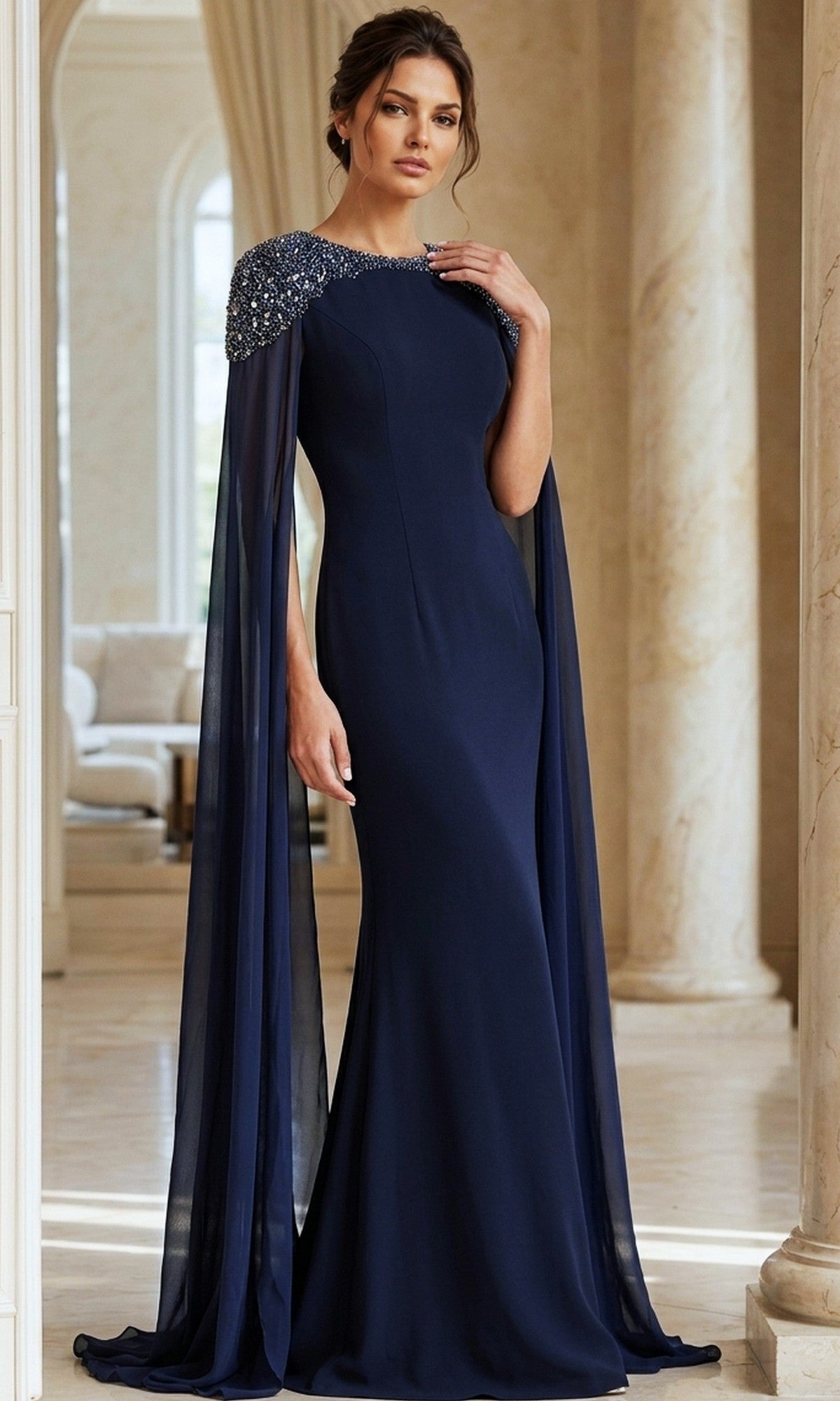 A woman stands in a marble interior wearing the Jovani 40000 long formal dress, an elegant floor-length navy blue crepe gown featuring chiffon cape sleeves and embellished shoulders.