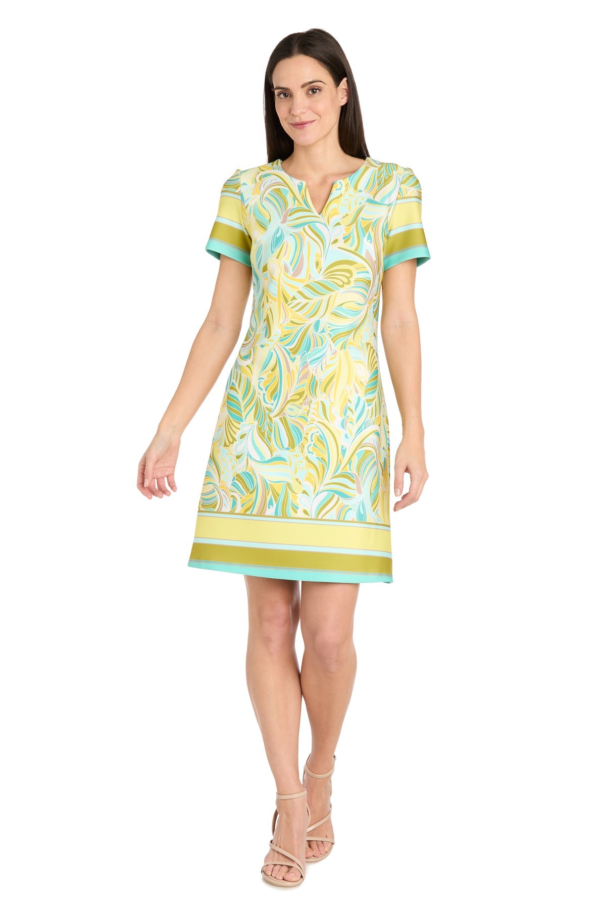 Woman wearing a vibrant Short Yellow Print Party Dress: R&M Richards 4026 with tan strappy heels, standing against a white background.