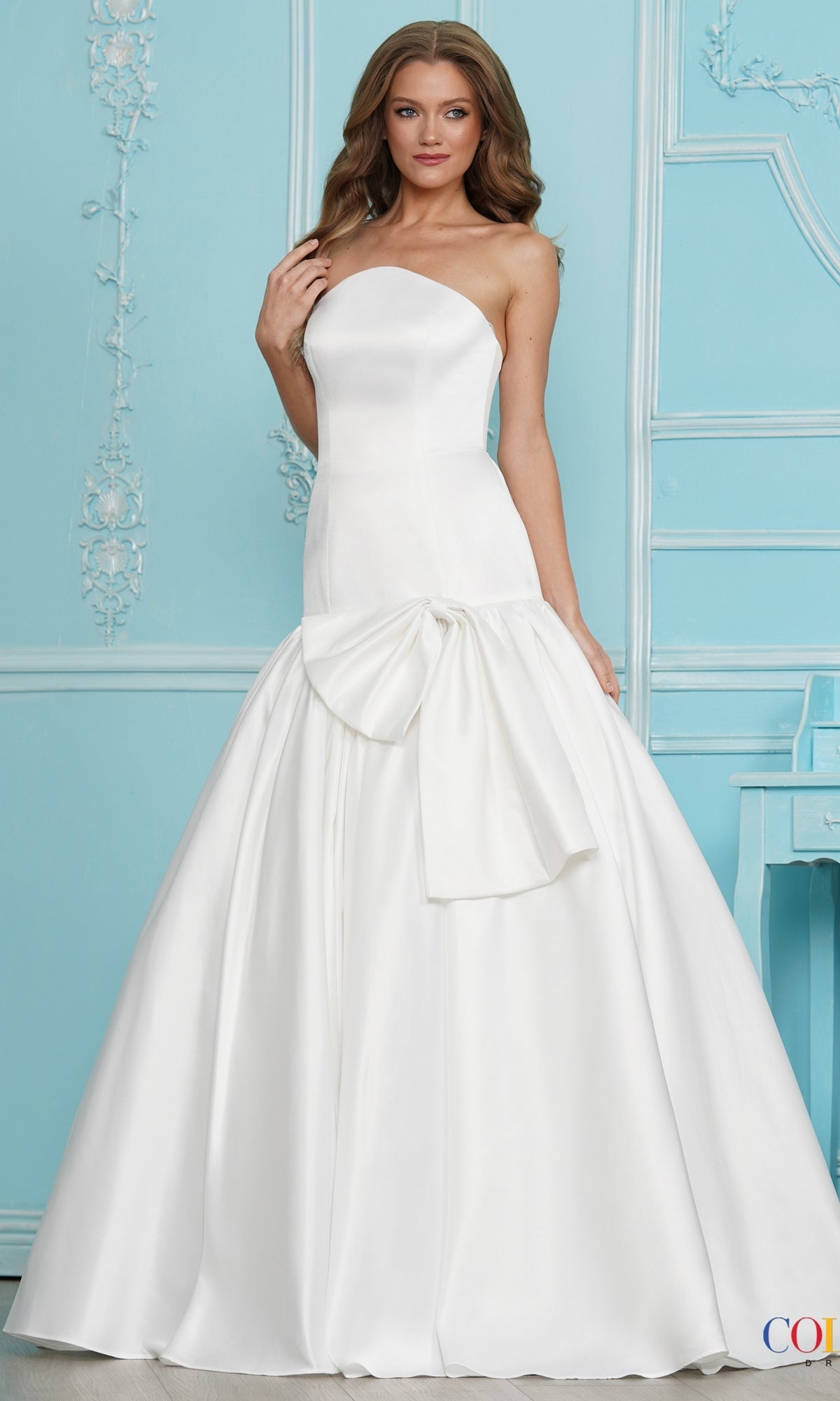 Long Prom Dress: Colors Dress 4058 off-white strapless satin ball gown with an oversized bow at the waist.