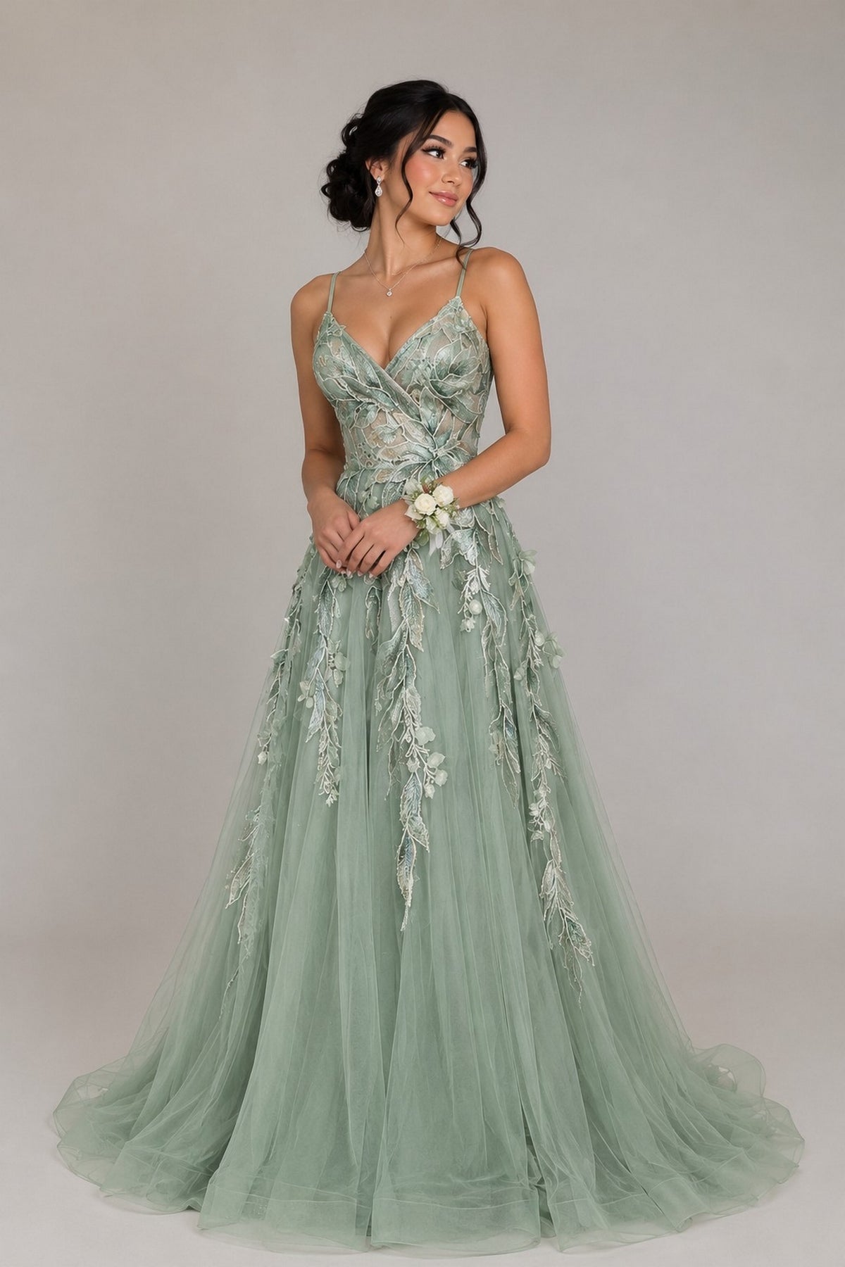 Amelia Couture 4073 sage green floor-length A-line gown with a V-neckline and intricate floral embroidery and leaf appliques across the bodice and skirt.