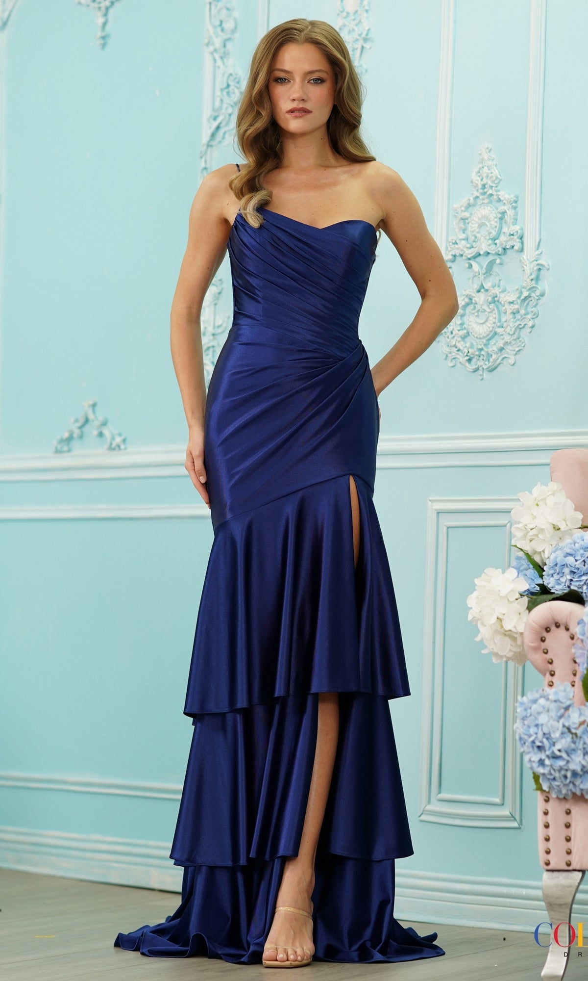 Long Prom Dress: Colors Dress 4110 in navy, featuring a strapless floor-length design with a pleated bodice, tiered ruffle skirt, and a side slit.